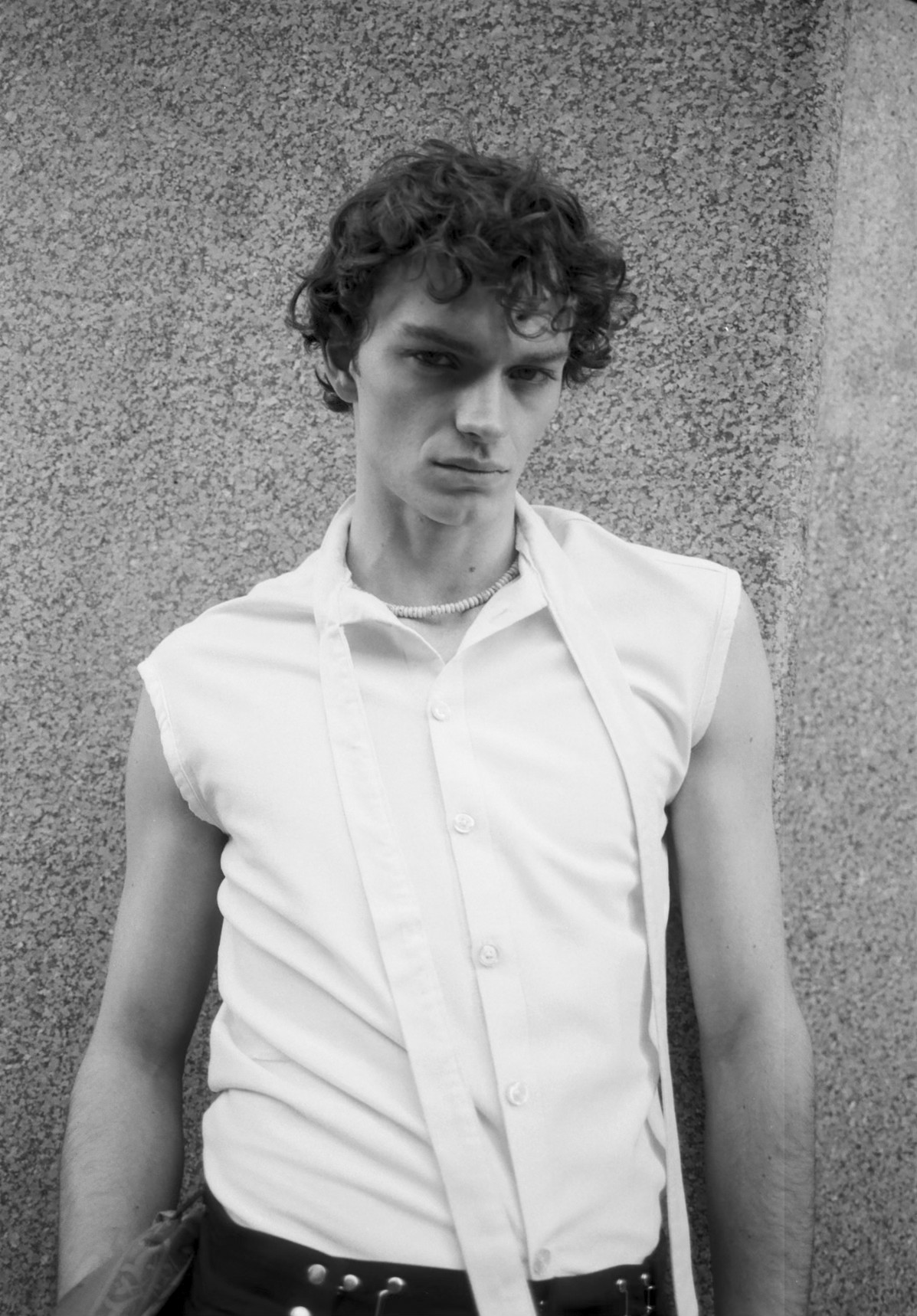 A person confidently wearing a styled outfit.