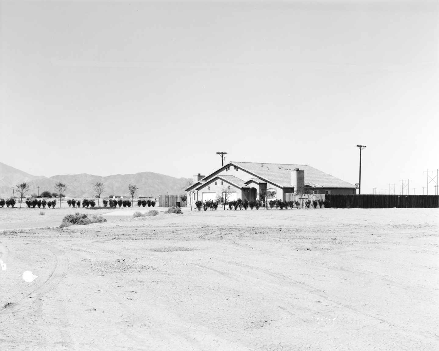 Tree lined driveway and home approximately 15.3 miles from test site. Silver Gelatin Fiber Print 2016