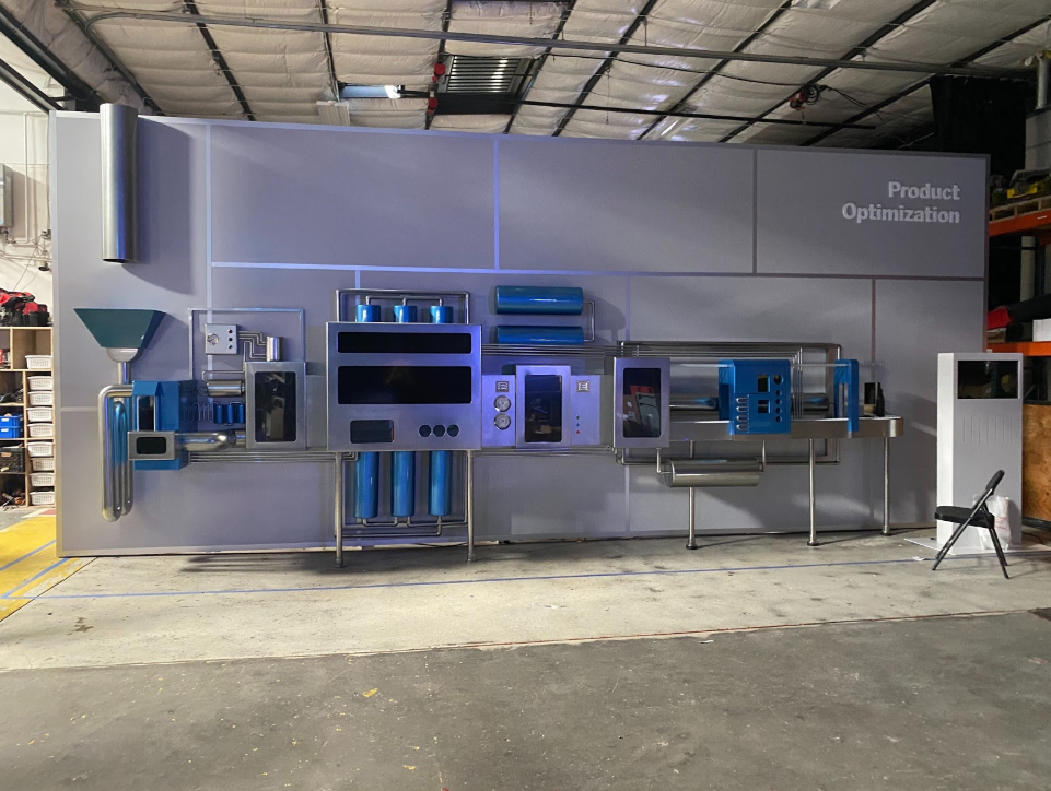 Physical build out of Product Optimization scene. Physical sculpture, hidden LED screens, physical conveyors, and kinetic sculpture.