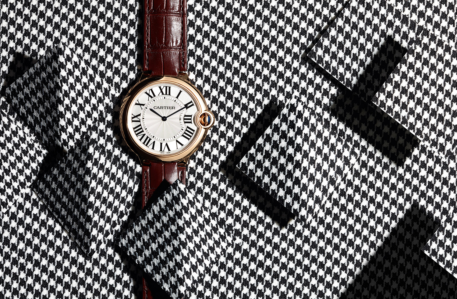 KMA photographer Isabelle Bonjean photographs Cartier watch against black and white checkered background 