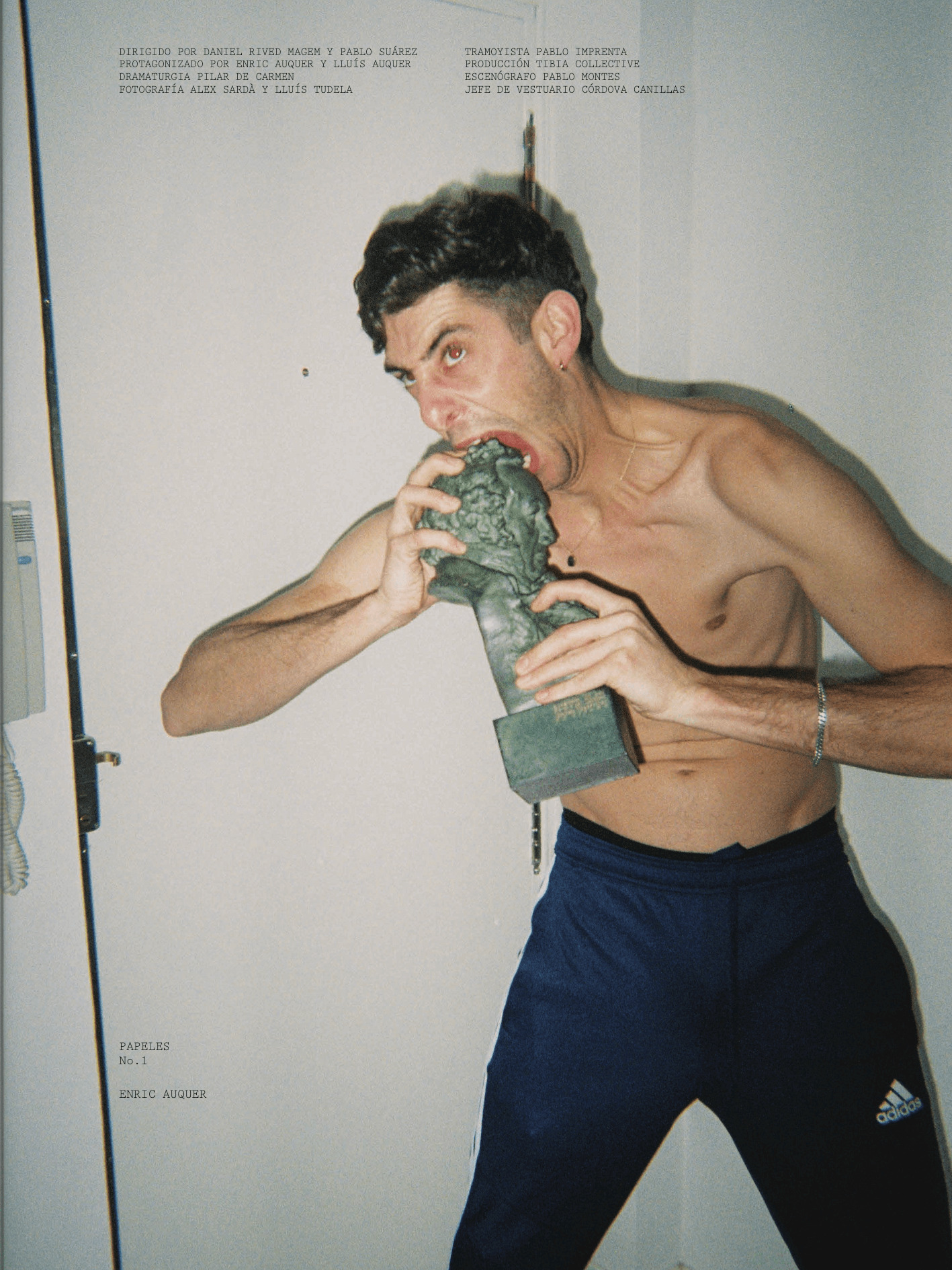 Shirtless Enric Auquer biting a Goya award