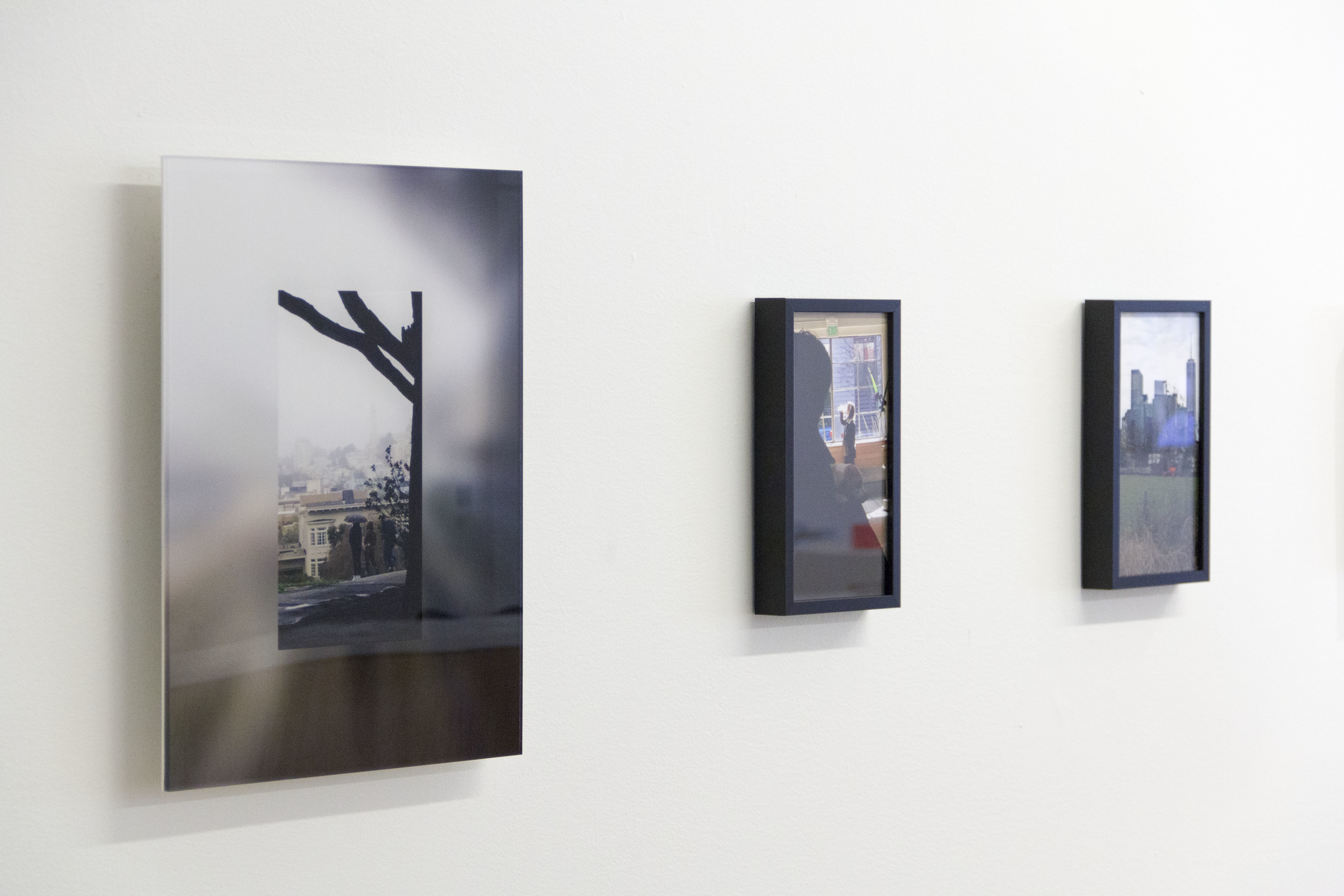exhibition image close up of three photographs of places people from follower app were.