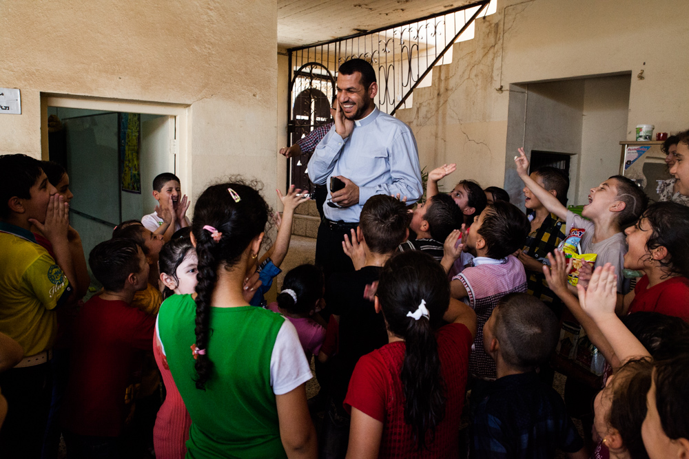Al Qosh, Niniveh plains, north Irak, 2015. Animations d'été pour les enfants. Aram est prêtre depuis 5 ans à Al Qosh. En ces temps difficiles, il estime que son rôle est de soutenir la communauté et de redonner espoir aux gens, malgré la peur de la guerre et les difficultés engendrées par celle-ci.