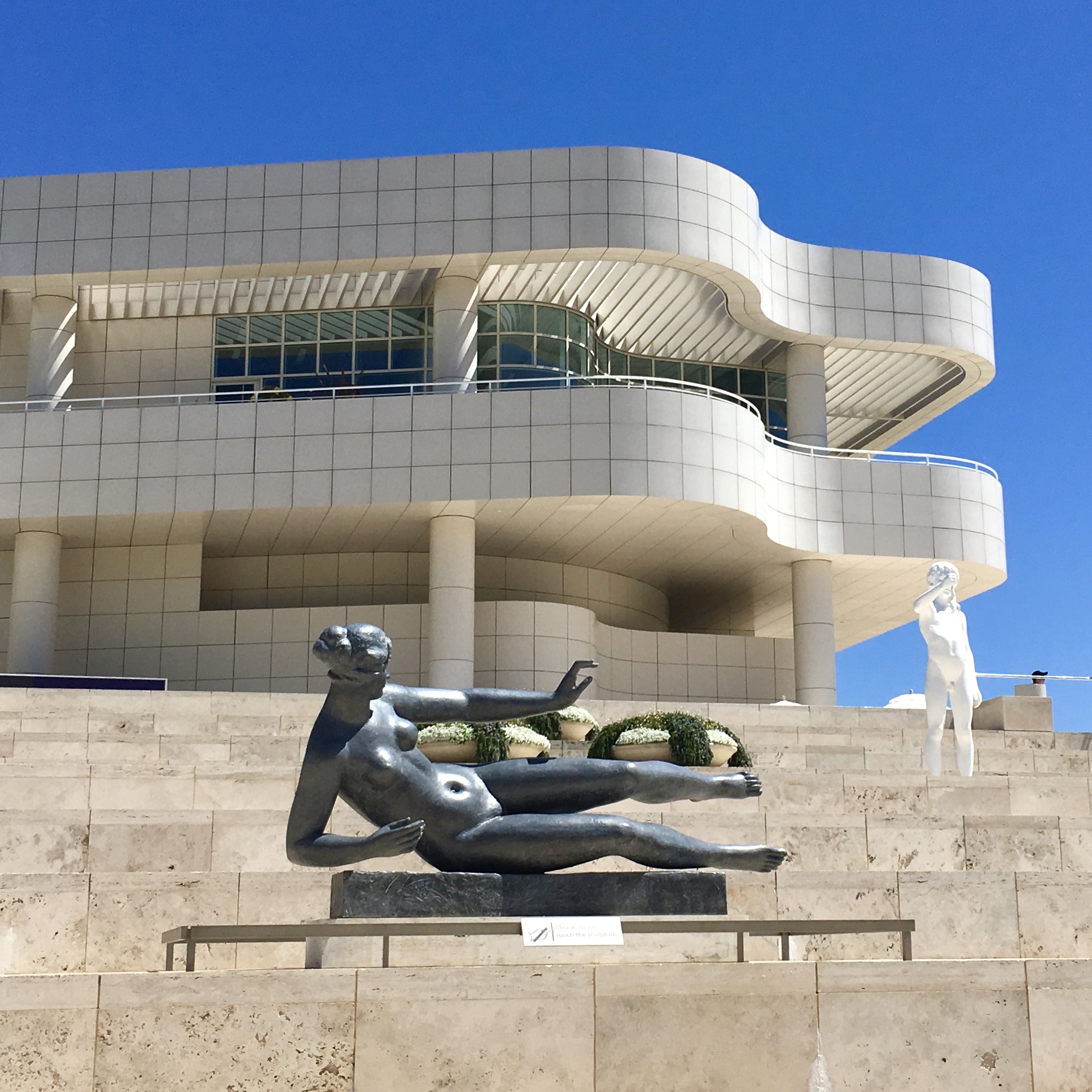 The front entrance of the Getty Museum in Los Angeles, California, features Aristide Maillol’s sculpture Air, framed by modern architecture and bathed in California’s golden sunlight.