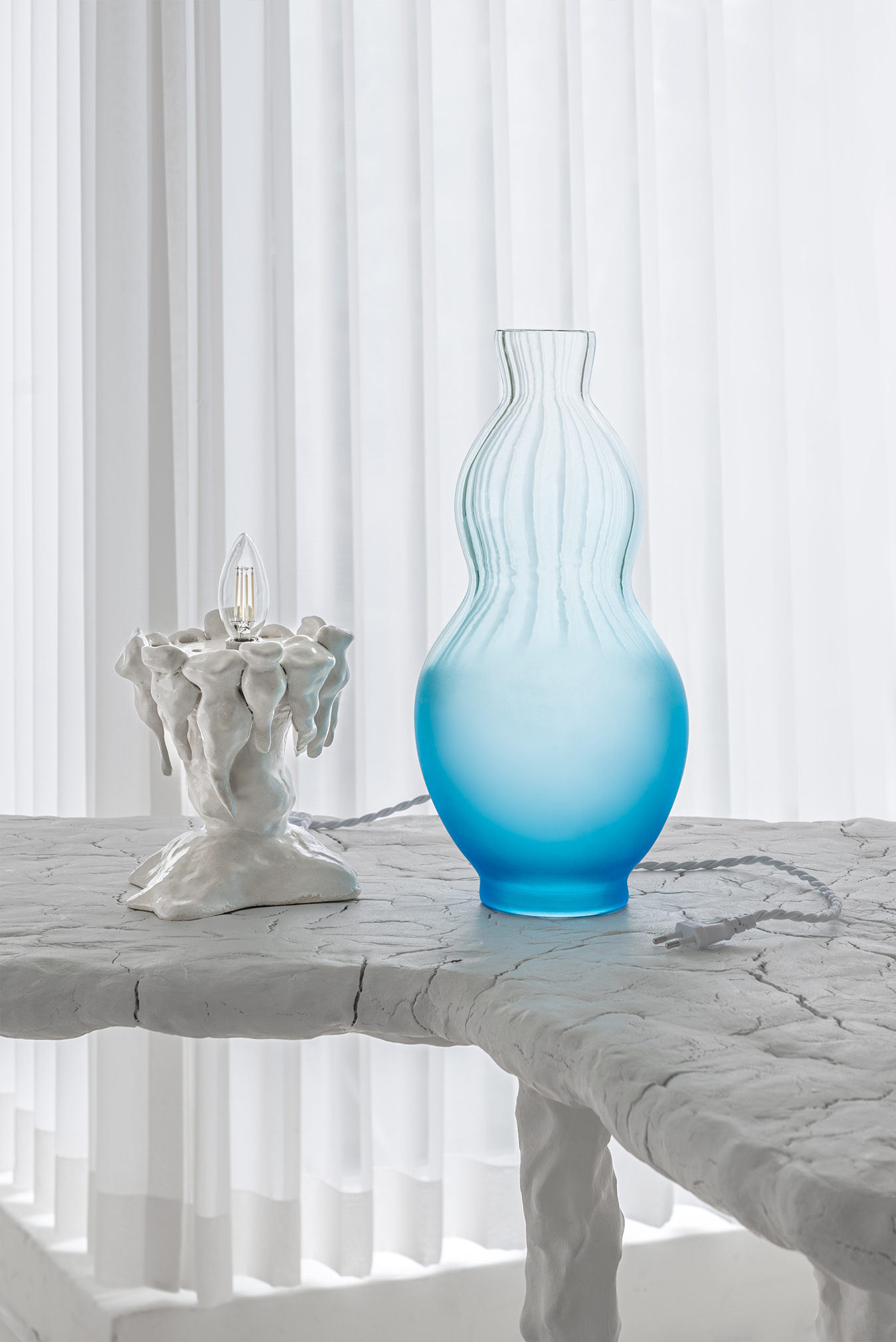 Plaja Studio, blown glass and porcelain lamp under construction in neutral white background