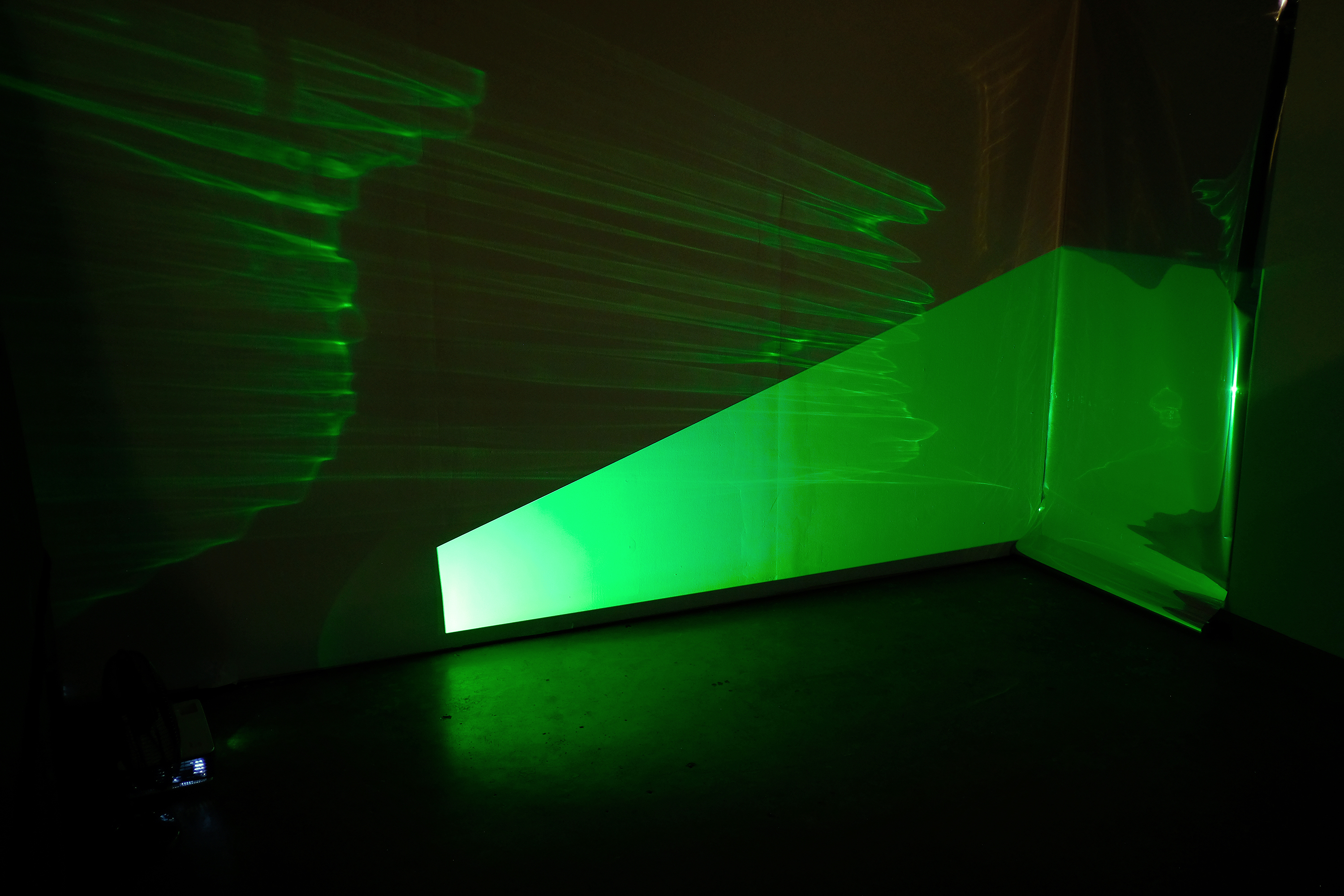  perception is memory is perception is... 2-channel video projection, mylar, mirror, fan, and rocks 2017. Photo credit: Erica Robert Pallo