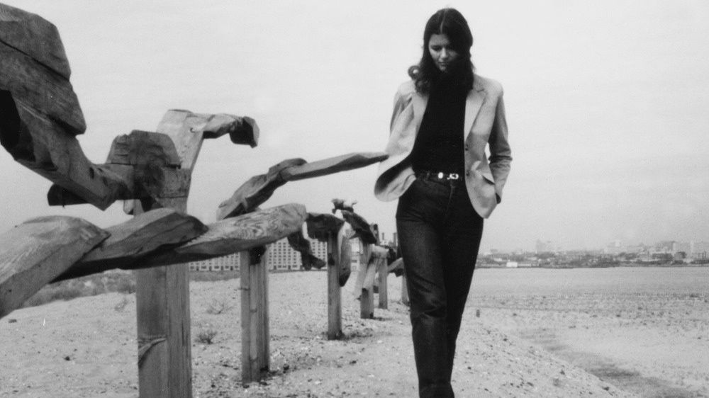 Von Rydingsvard walking beside her work Saint Martin's Dream in Battery Park, New York, 1980.