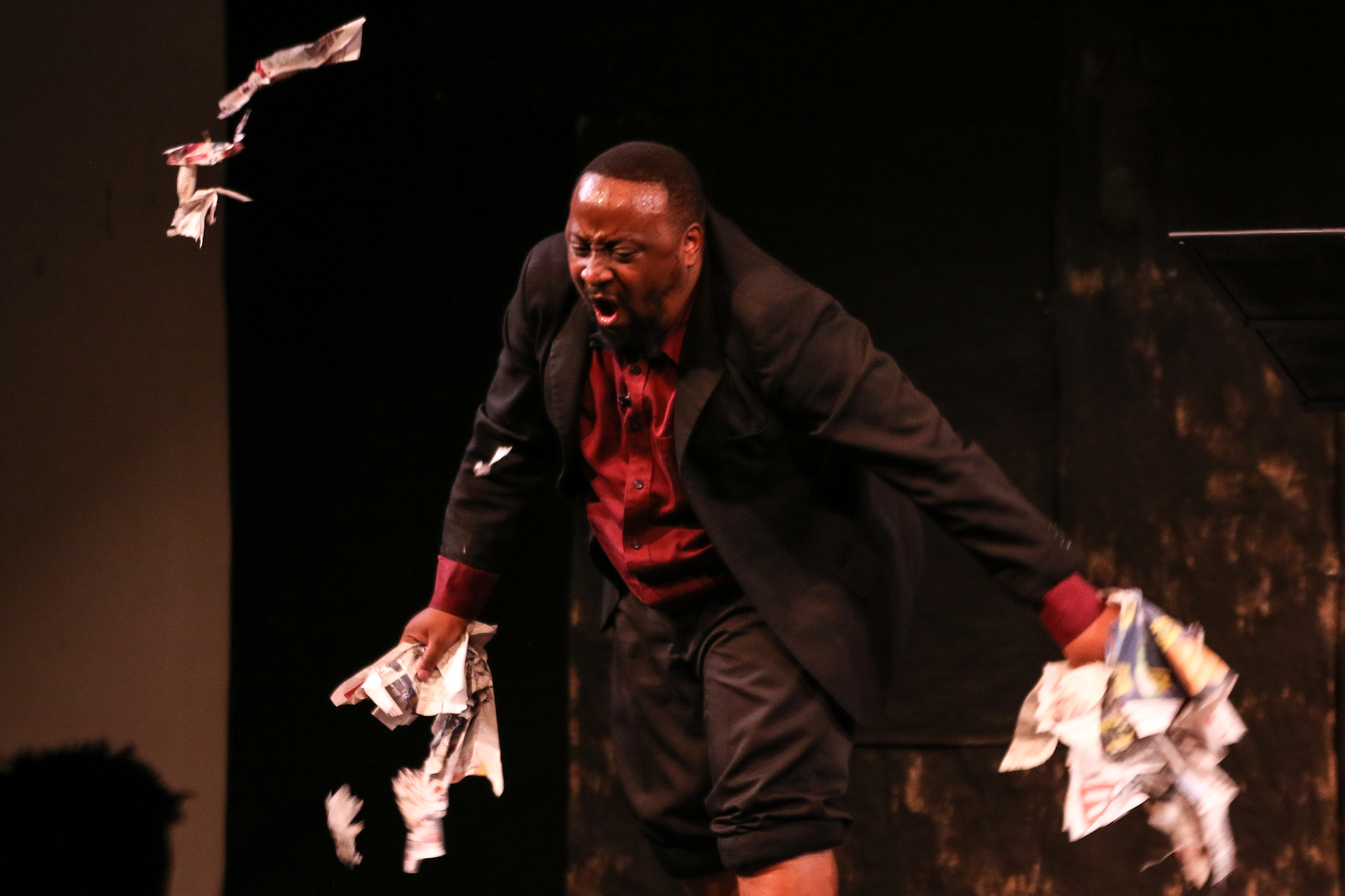 The same man ripping up newspapers in anger.