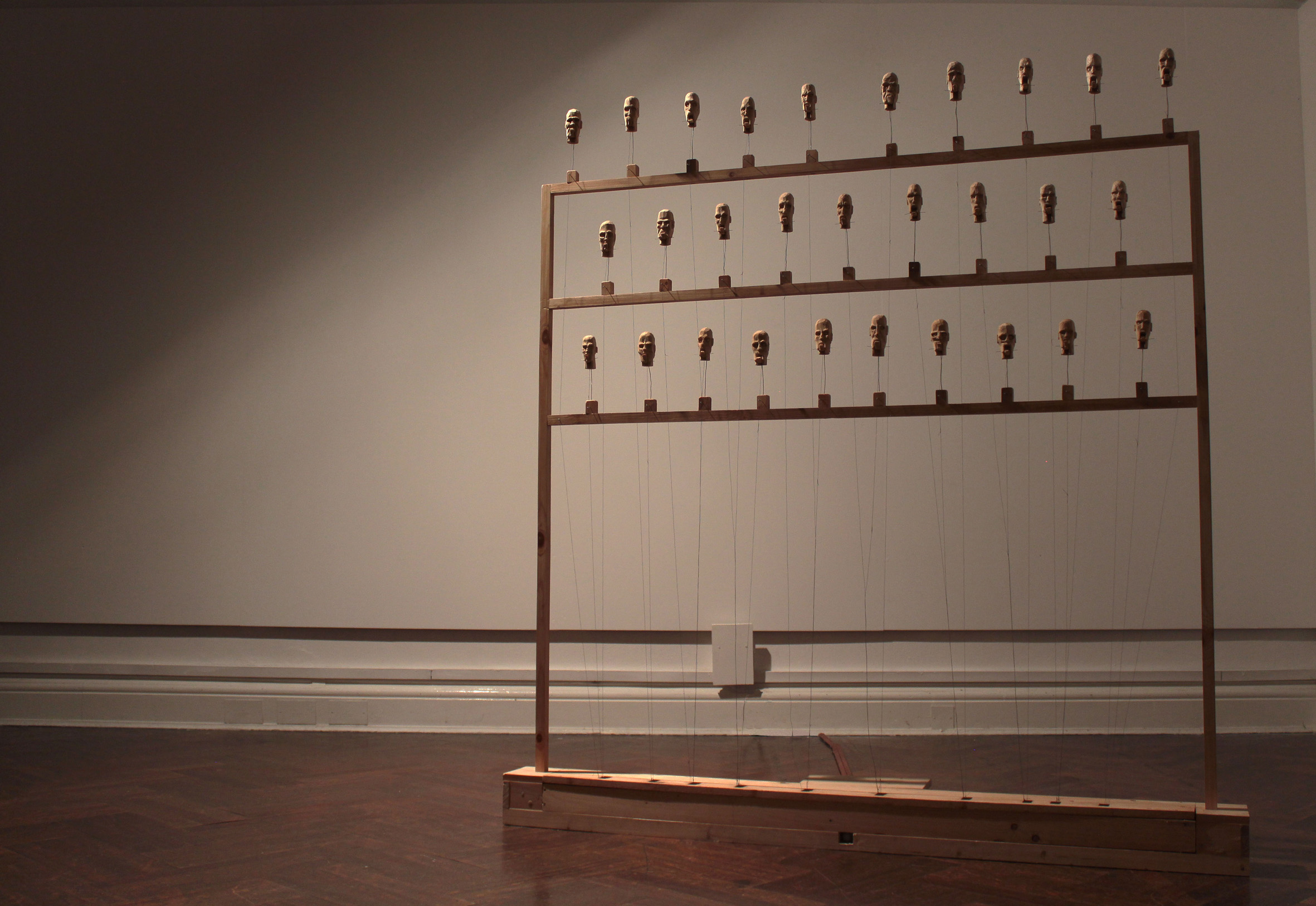 Doubt Ensemble. 2017-2019. Pine wood, found timber, thread, lace pins, steel wire, motion sensor, electronic components. Dimensions: 175 (w) x 190 (h) x 27 (d) cm.