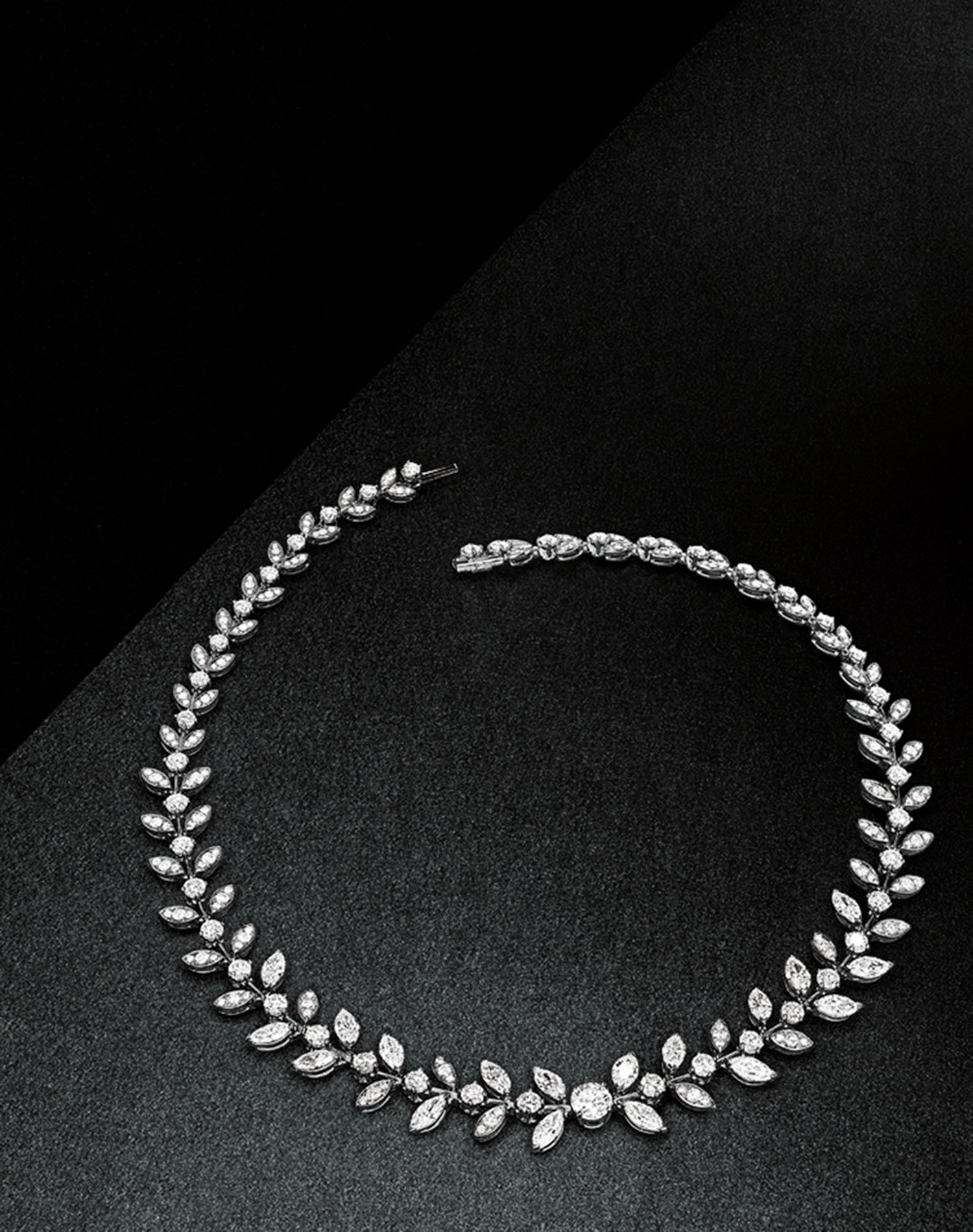 KMA stylist Sara Wacksman designs set for a photo of a diamond necklace with gems shaped like tear drops on a black surface