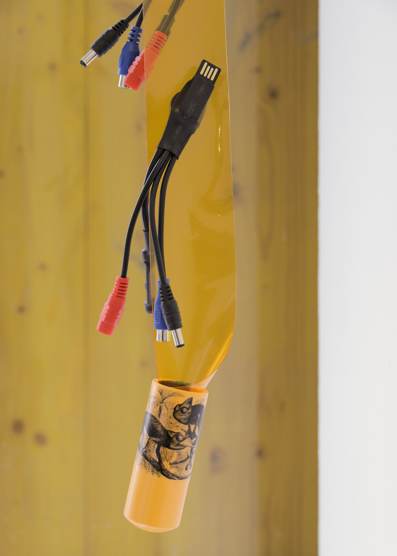 If the walls had eyes (detail), 2023, electronic listening devices, welding curtain, pvc, magnets, decal, 32 x 6 x 5 in. (81 x 15 x 12 cm)