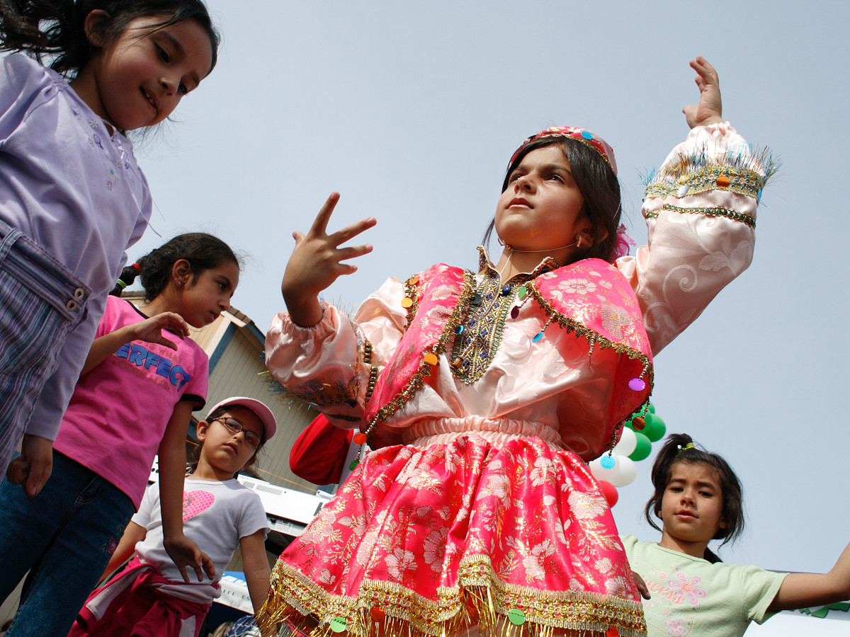 Shadi Roueenfar, 7, wears a traditional costume while leading other children in an Iranian folk dance at the Norooz Persian New Year festival in Irvine, California, on March 27, 2005. Ho-Yen Tsang for The Orange County Register