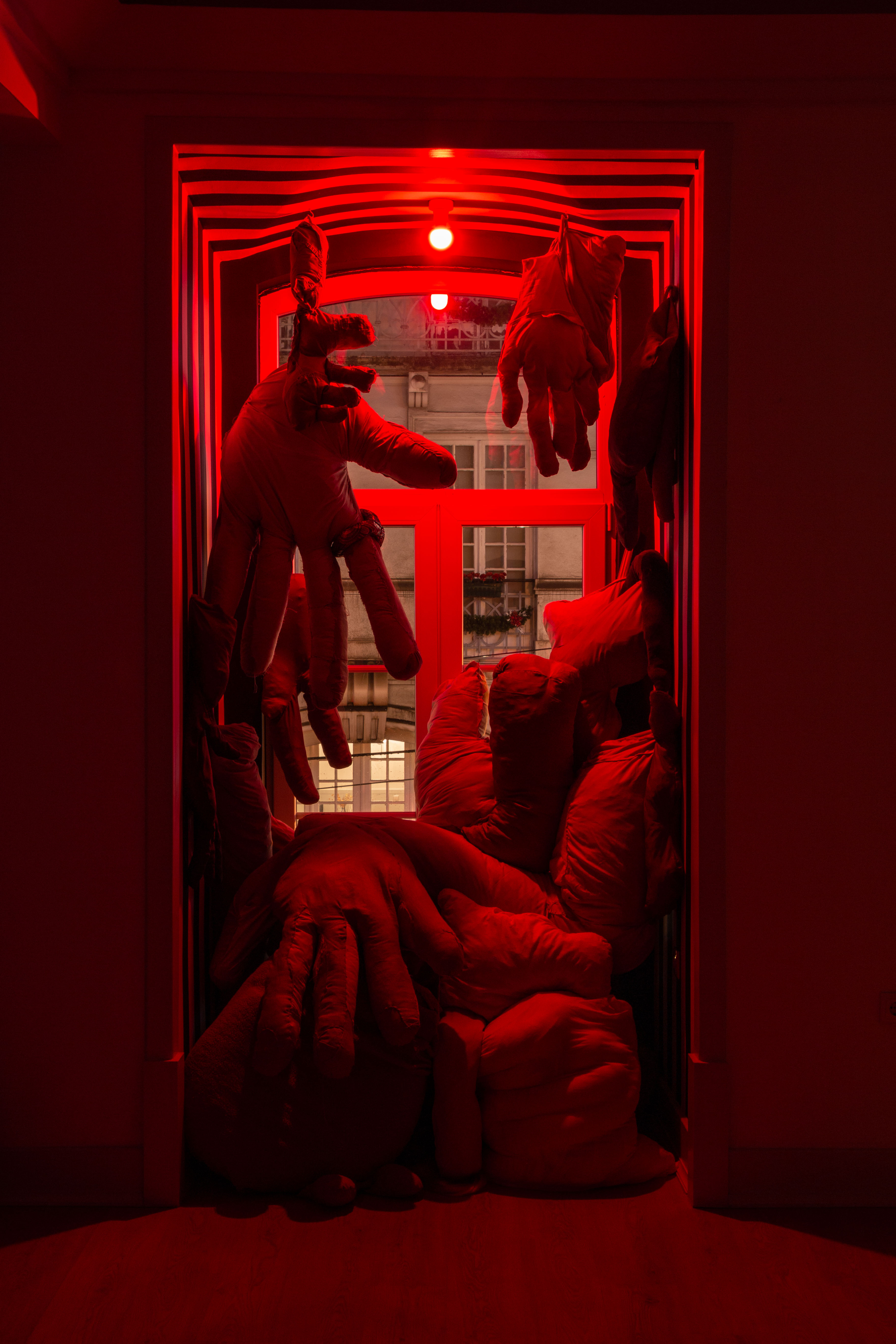 demasiado, 2022 (site-specific; fabric, foam, fiberfill, sheets, second-hand clothes, red light; ~290x145x100cm) [see more]