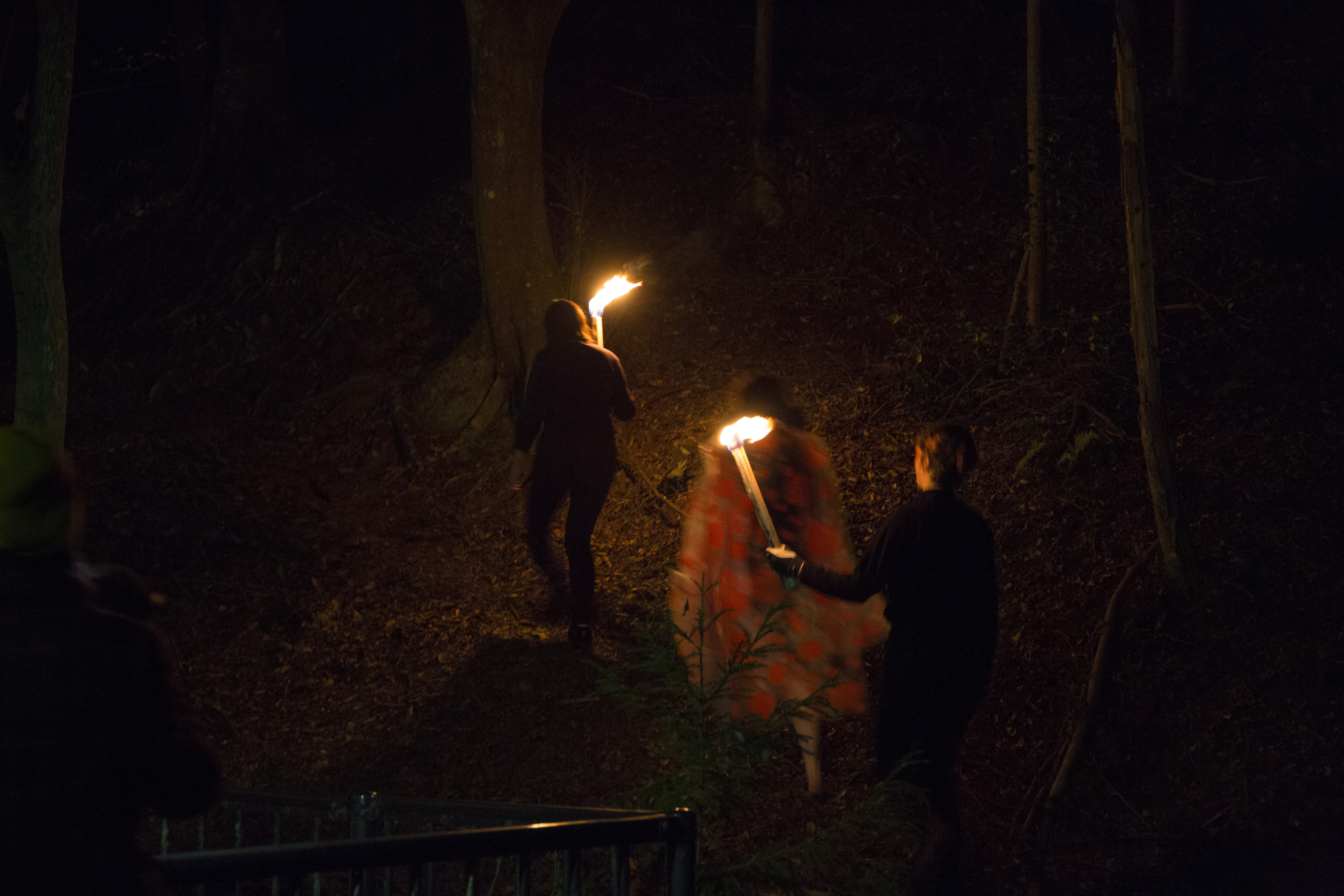 The shaman carries a handcarved marble monolith, barefoot in procession