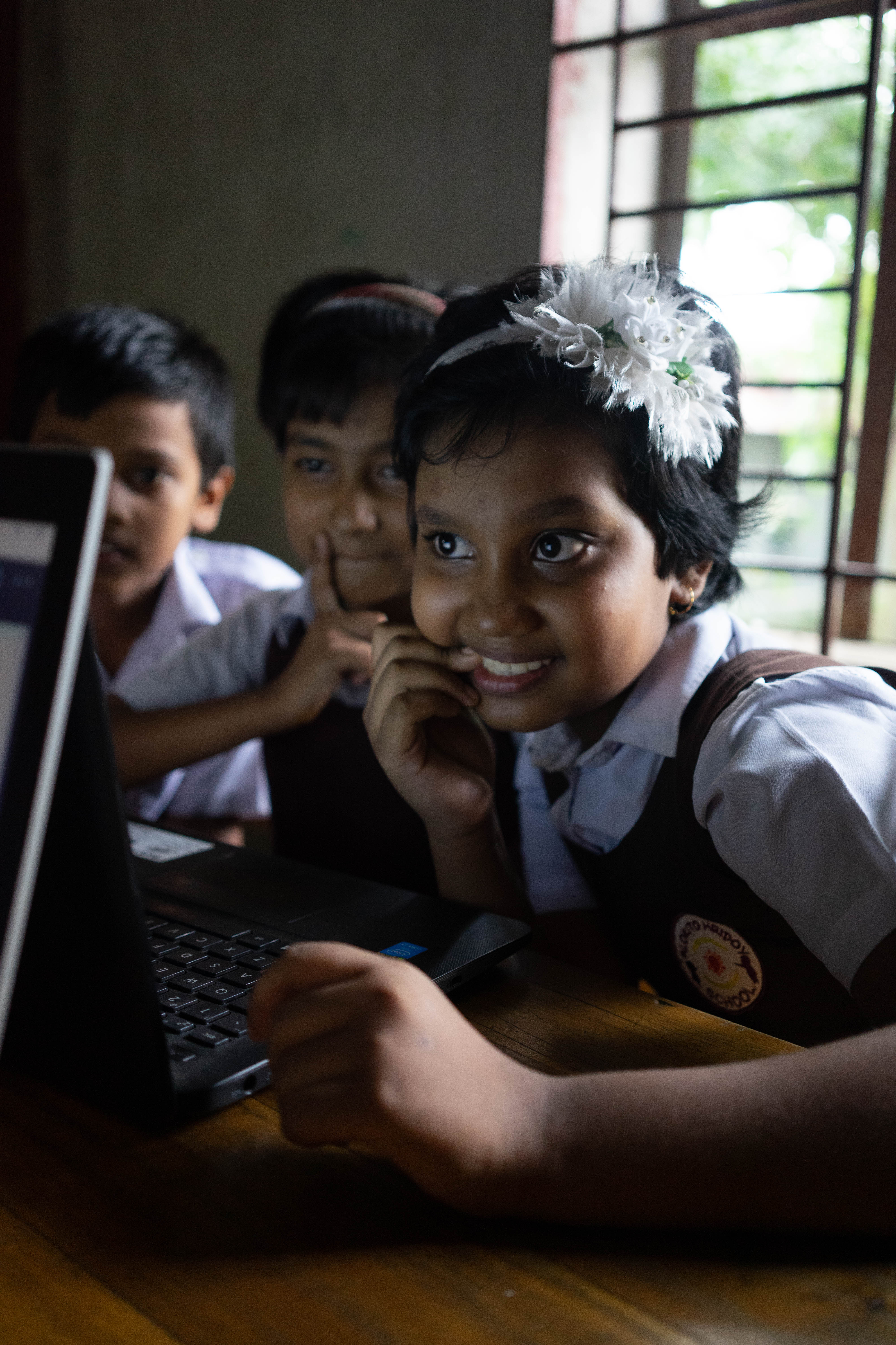 Commissioned for Alokito Hridoy Foundation. Alokito Hridoy has created a new model of education that they hope can scale throughout Bangladesh. Beginning with a low-cost charter school in on the outskirts of Dhaka that caters to the children of factory workers, Alokito Hridoy hires local teachers and develops new training models to ensure a human-centered 21st-century-focused education. Their model also excludes a focus on technology, and here, students practice math lessons on a school laptop.