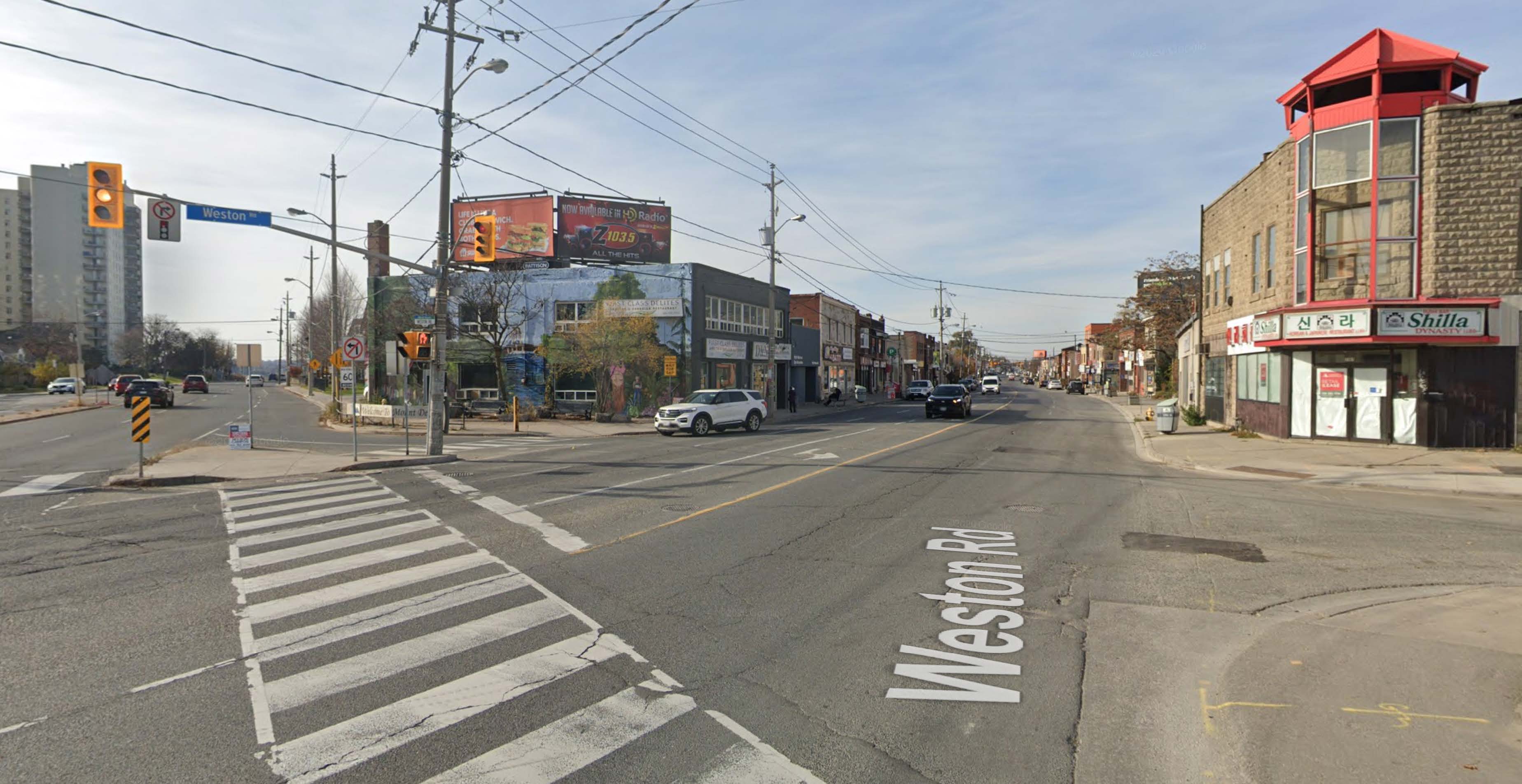 Weston Rd. looking north showing pedestrian island created in 1967. Graffiti has been painted onto the remnants of the demolished commercial building.