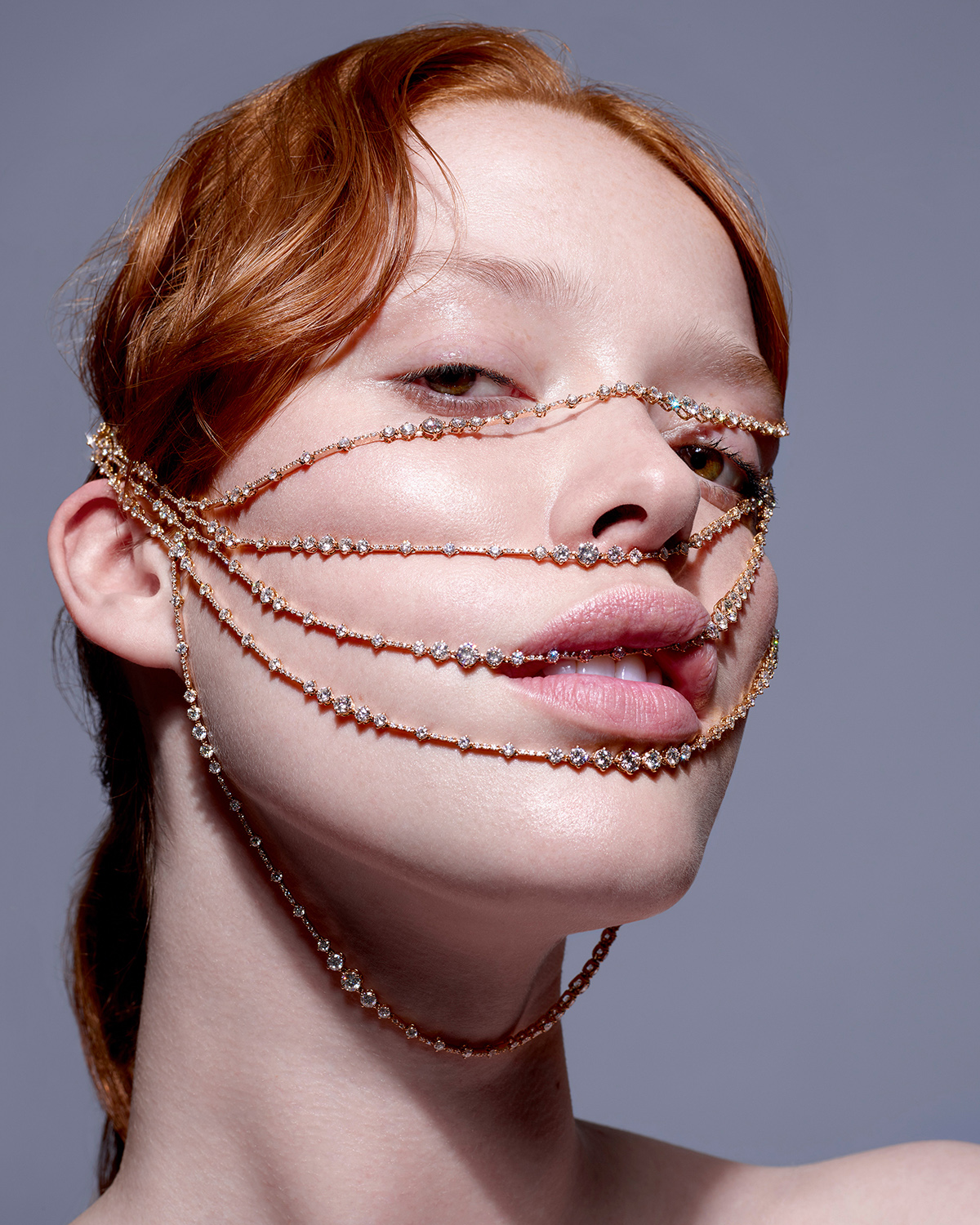 KMA photographer Isabelle Bonjean shoots close up of female model with red hair and diamond necklace draped over her face for Citizen K