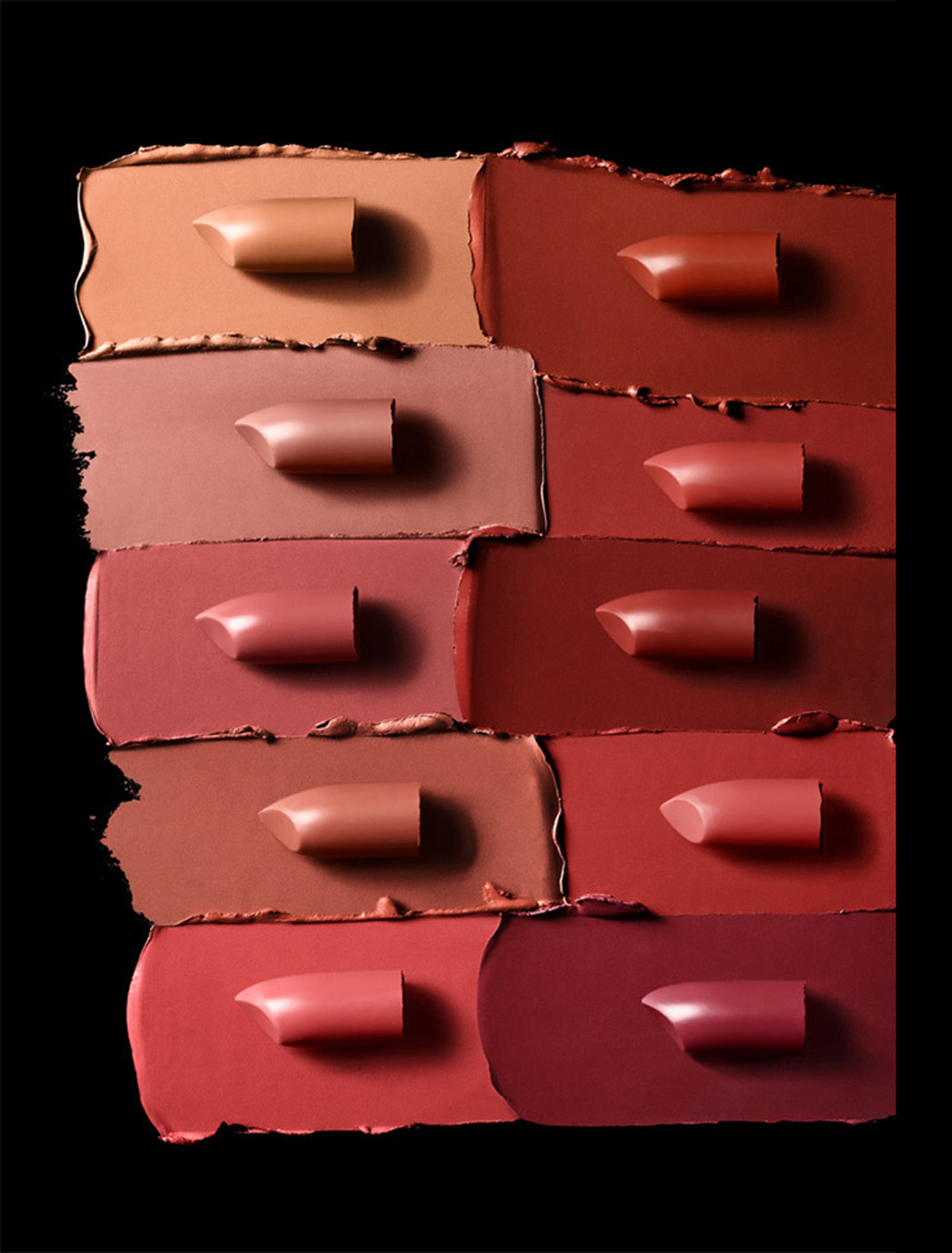 KMA stylist Sara Wacksman designs set for texture photo of smeared shades of Maybelline lipstick against black background 