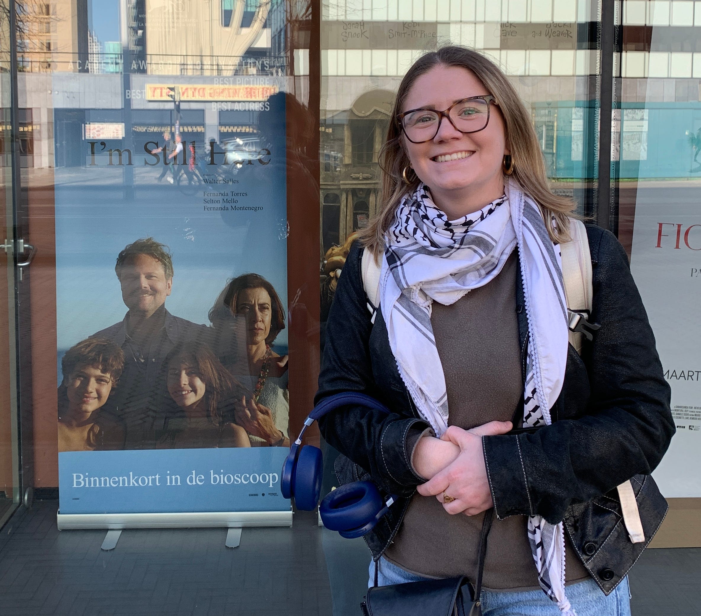 Gaia standing by the poster of “I’m Still Here”