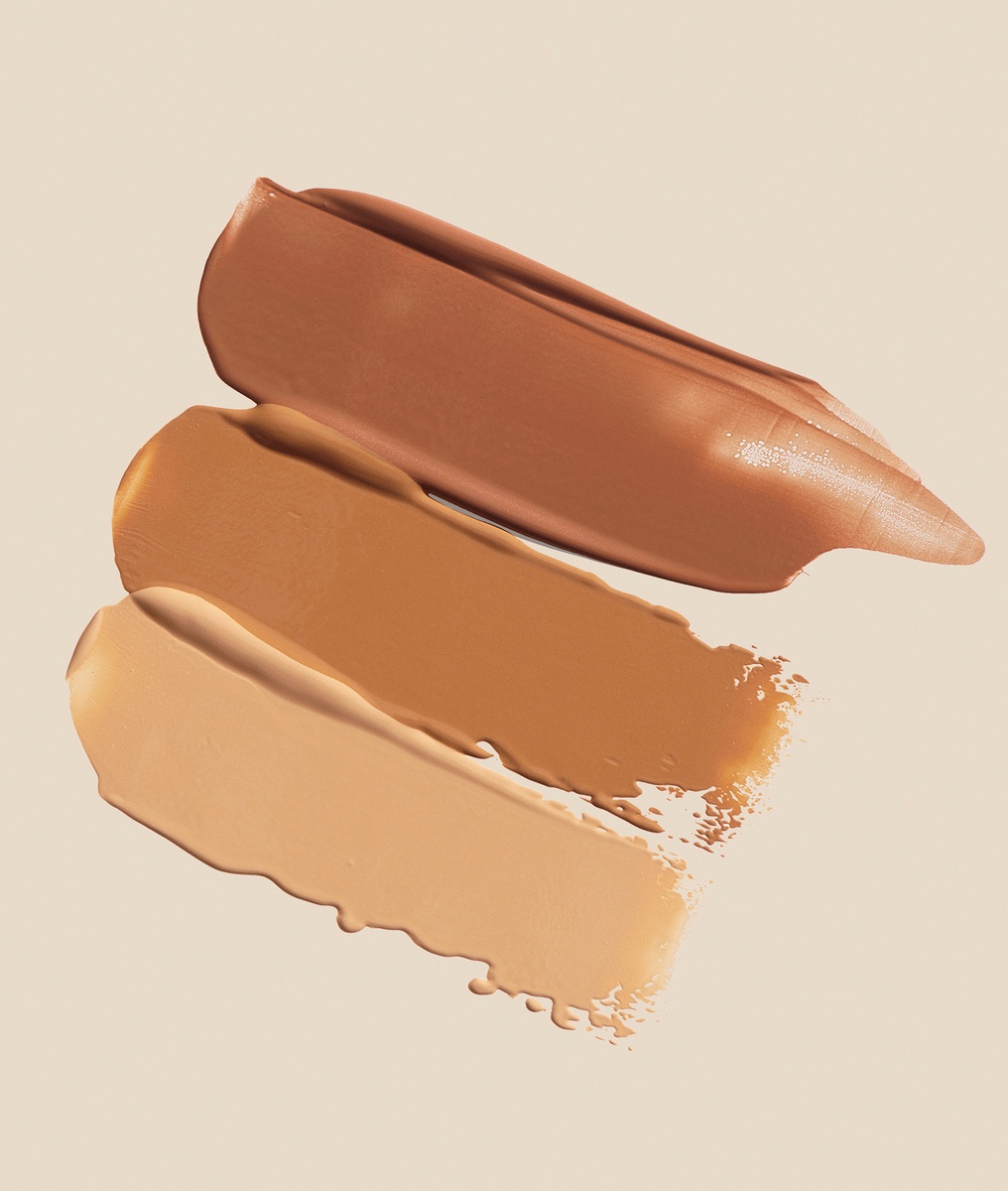 KMA photographer Mattias Nyhlin photographs three shades of foundation smeared on brown background for Kicks