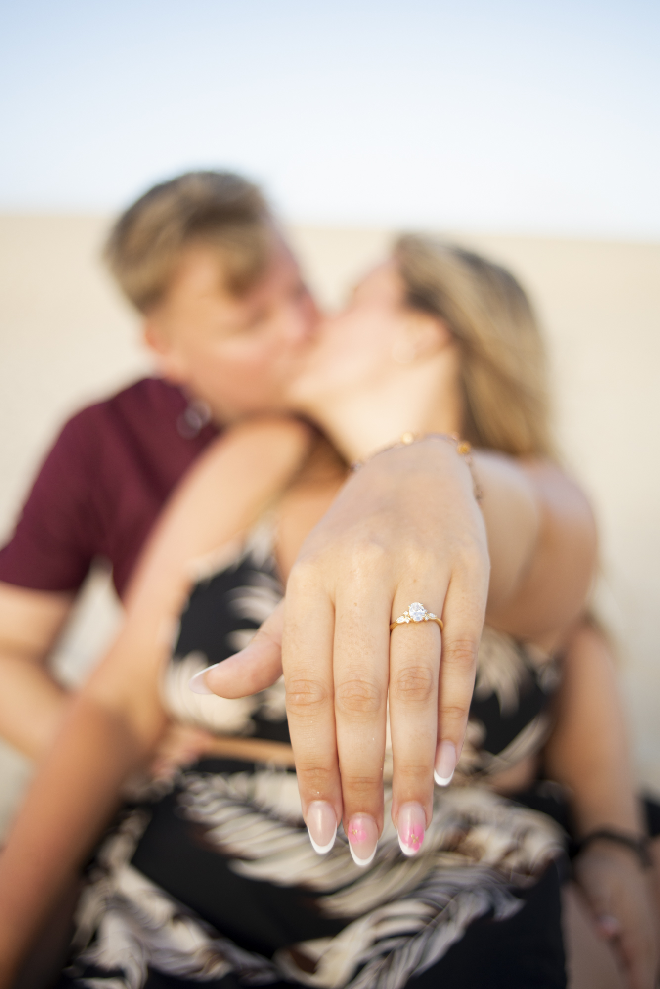 Woman proudly showing her engagement ring during proposal photoshoot