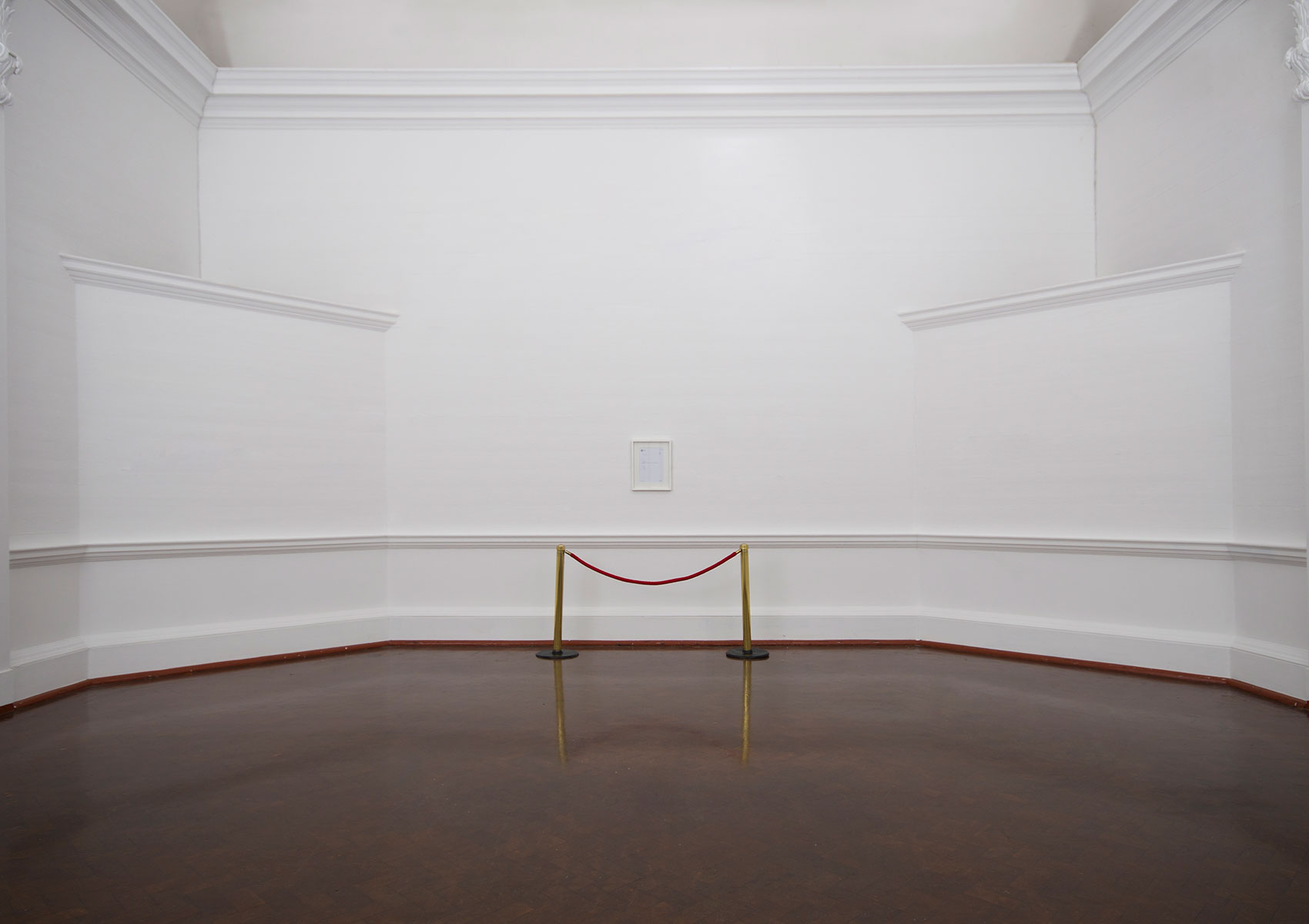 James Webb, Scream (2008) | Signed certificate, museum barrier, speaker, audio, dimensions variable | Installation view, Johannesburg Art Gallery, Johannesburg | link to audioScream is an intervention at the Reina Sofia, Spain’s national gallery, where members of the museum’s staff were invited to scream at Pablo Picasso’s Guernica. Because the Picasso family own the rights to the painting’s image, the artist was not allowed to document the project visually. The artwork is presented as a spacious installation in a white cube with the signed certificate of permission from the Reina Sofia on display and audio recordings of the screams broadcast from concealed speakers.