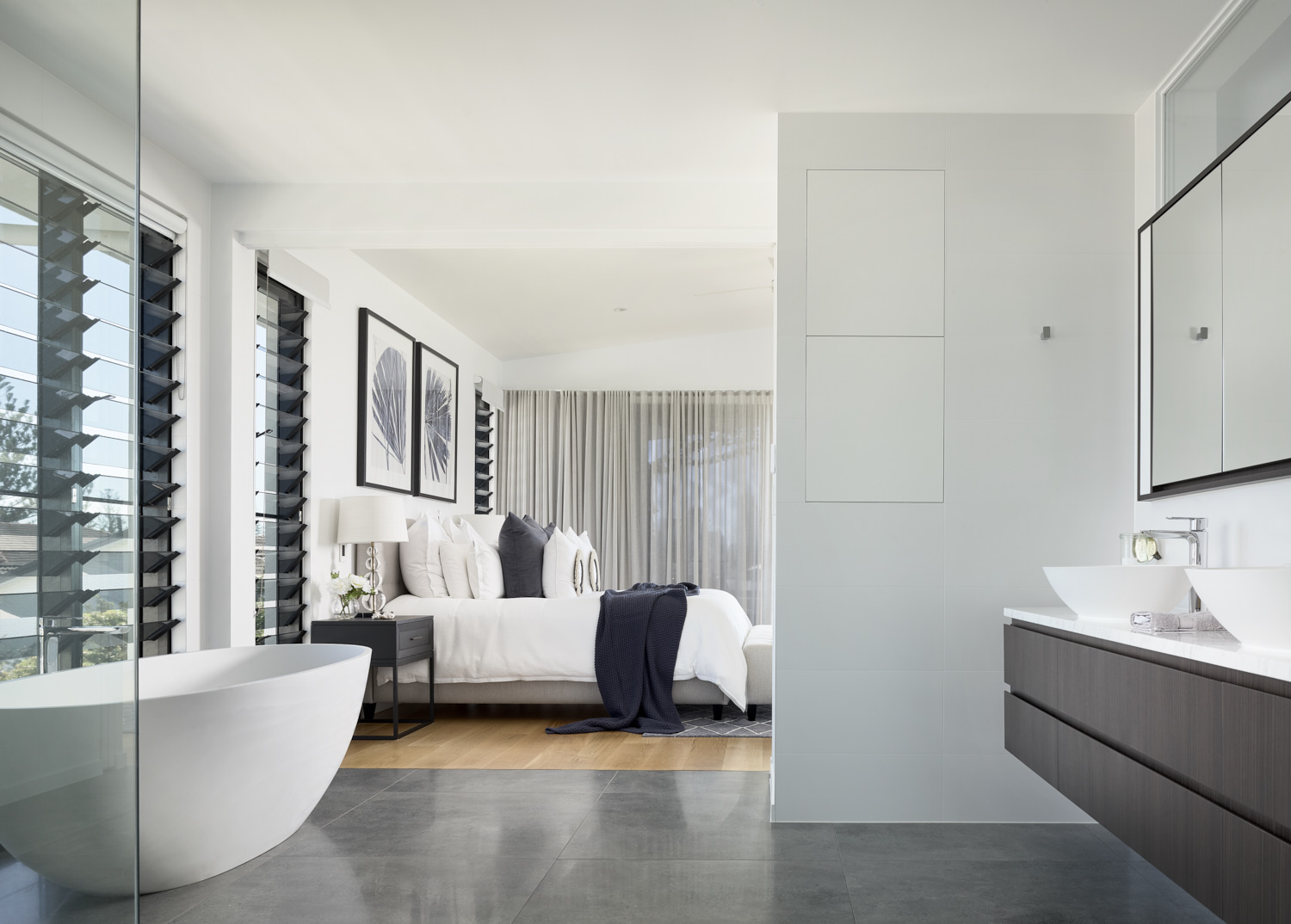 A contemporary bathroom featuring a spacious bathtub, connected to the master bedroom.