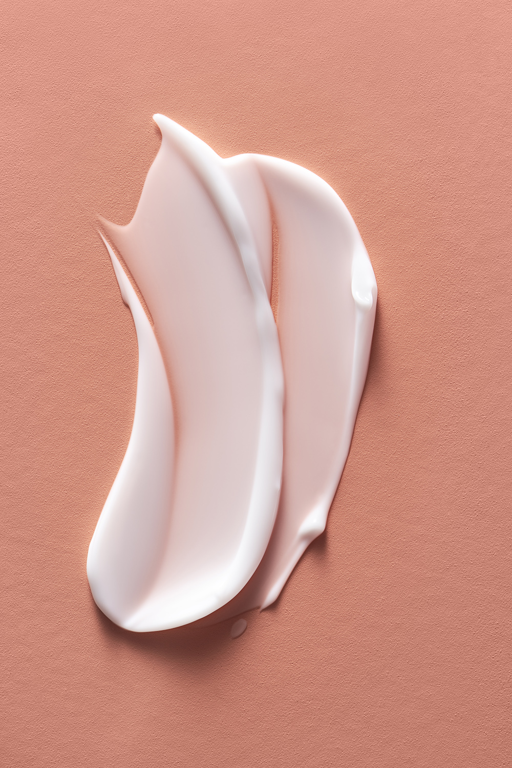 KMA photographer Mattias Nyhlin photographs creamy pink lipstick smeared on pink background for Kicks