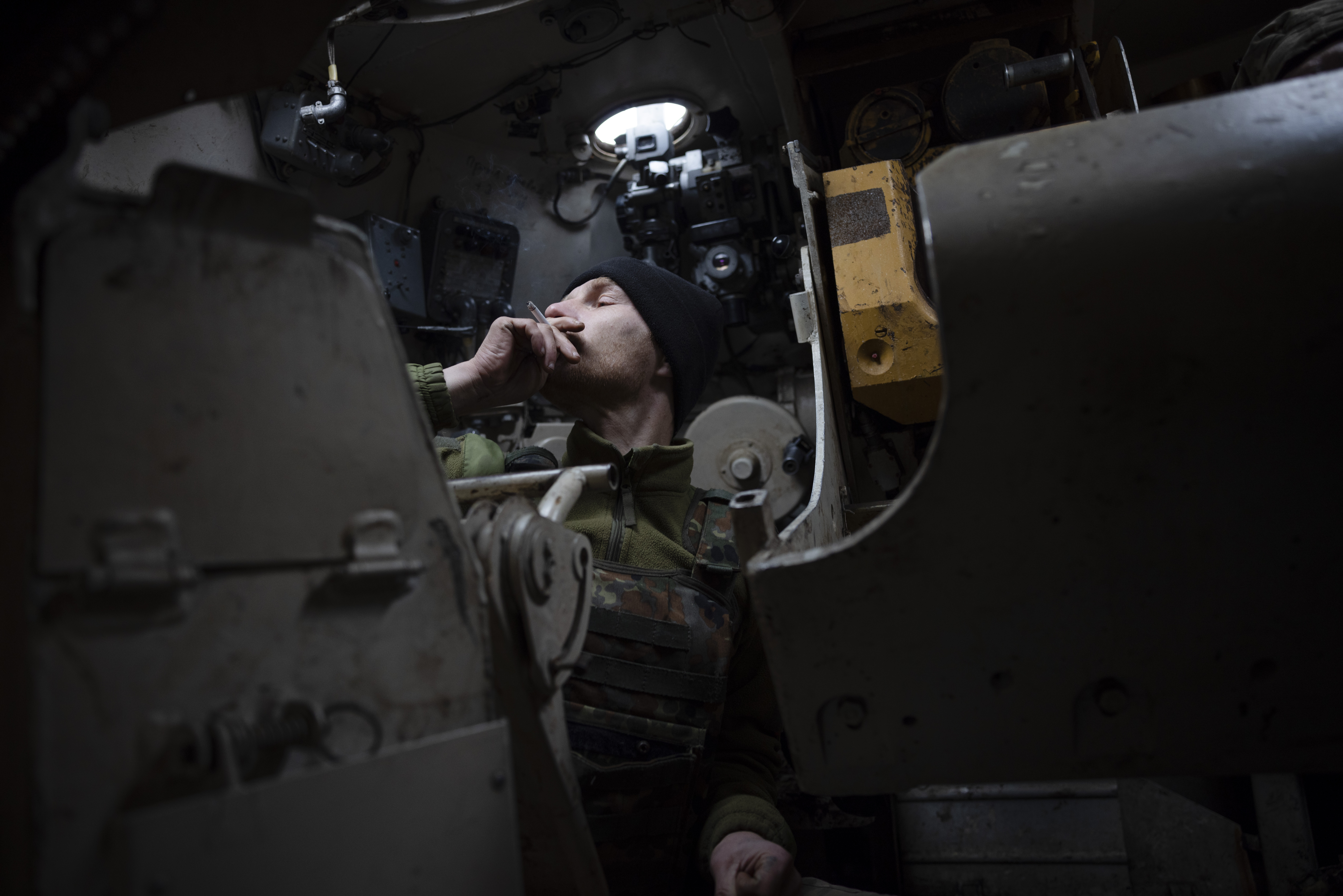 Russian positions are about five kilometres away. Dull rumble of artillery fire shakes the ground once a while. Saša stops to have a smoke inside a self-propelled howitzer before he needs to shoot again. The team adjust the direction of the fire a couple of times before it hits its target. Faces look blank; one could not tell they have just succeeded in the task they were given.