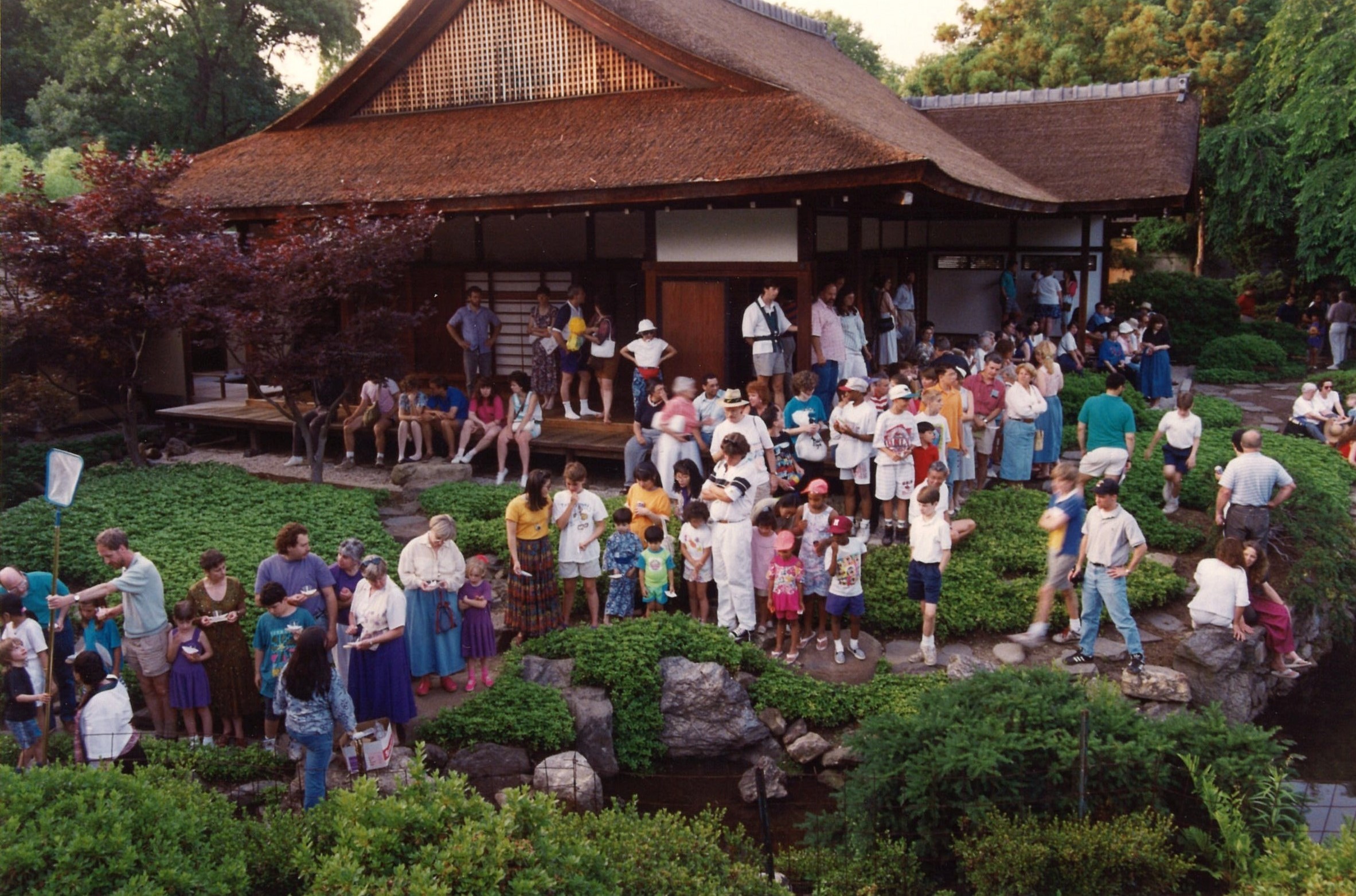 Visitors to Shofuso celebrate Obon by floating paper lanterns in the pond, 1999