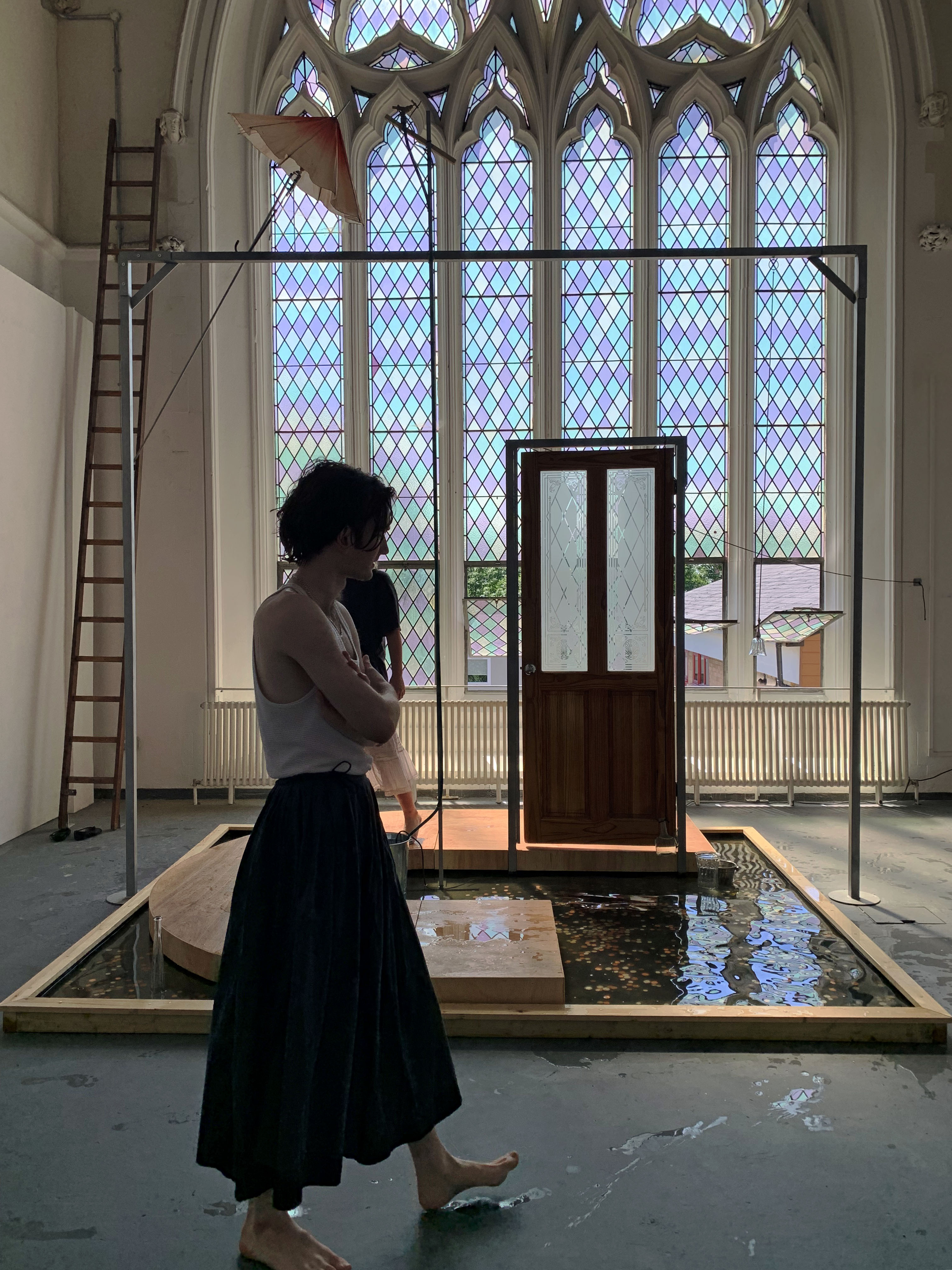 Water me gently, or not (2021) Photographic documentation of live performance showing at Goldsmiths Degree Show 2021, performers -  Lucas Evamy and Anna Dwyer