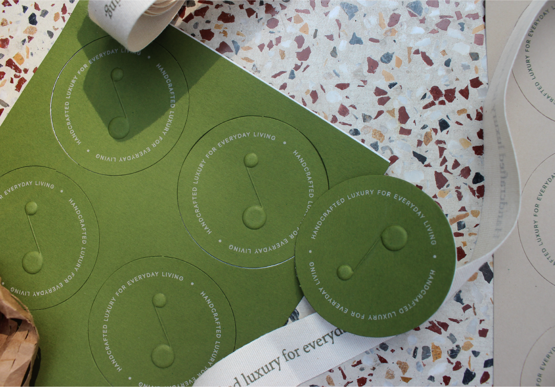 Custom Tula stickers in two colour tones — used extensively in packaging