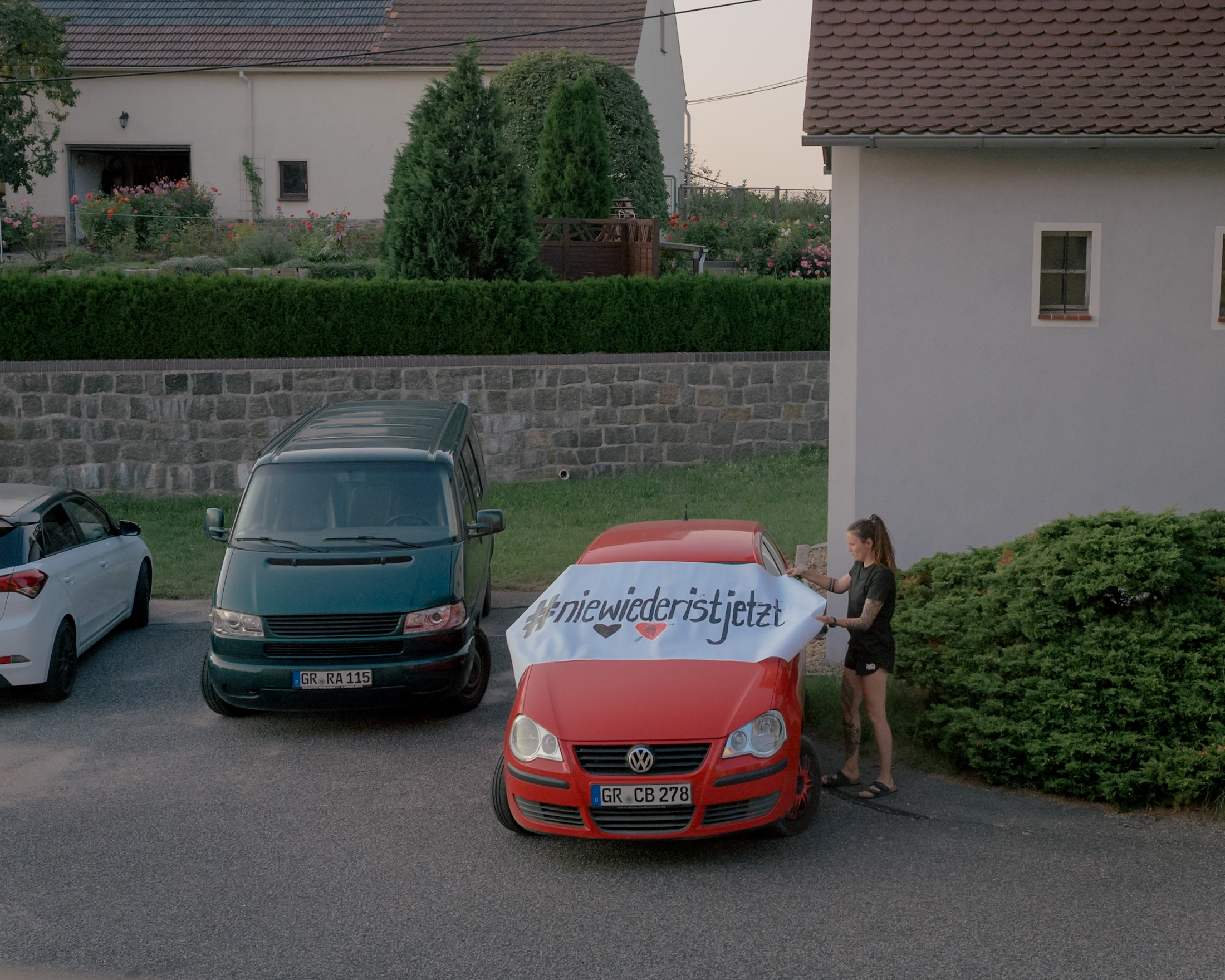 A villager protests alone with a banner in front of an election campaign event of AfD politician Sebastian Wippel at the restaurant German Oak in Tetta, Germany on August 20, 2024. The banner reads #niewiederistjetzt (#never again is now). The hashtag serves as a call to take a stand against anti-Semitism, racism and xenophobia and alludes to the crimes of the Nazi regime and the Holocaust.