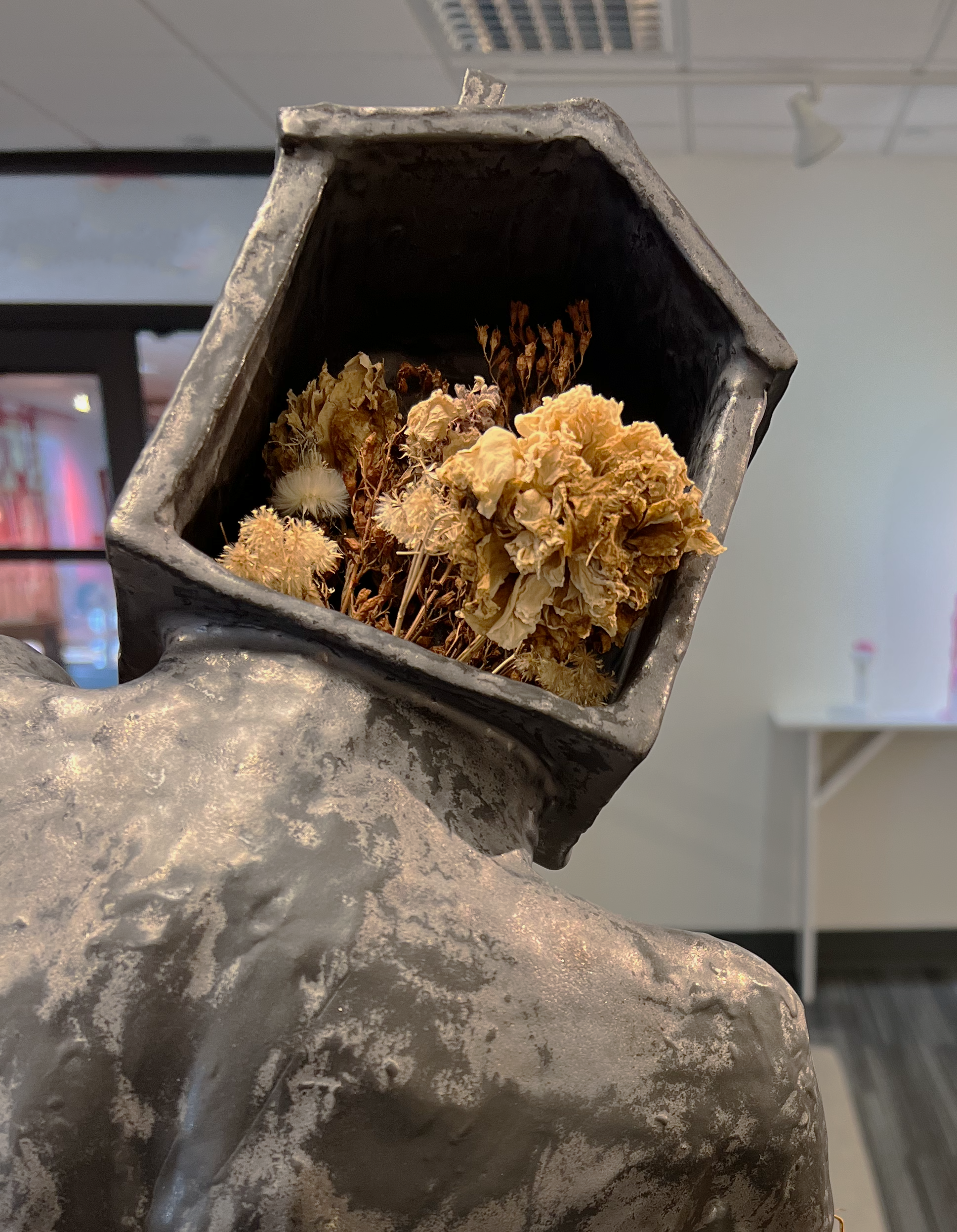 Innocence. 2022. 13 x 18 x 8 inches. Earthenware, glaze, dried plants.  