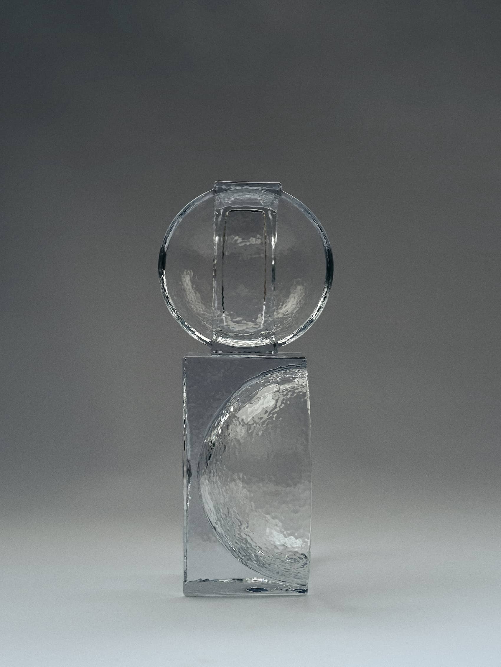 FORMA FOR HOLMEGAARDWith its weighty, sculptural constructions in solid glass, Forma is a product series rooted in the historical Bauhaus era, where shapes like cubes, spheres, and cylinders served as primary design elements. Forma embodies the same graphic strength through massive geometric shapes intersecting with one another. This bold design language engages with the negative space surrounding the structure, influencing how the brain interprets the fusion of forms.Designed in collaboration with Laura BildeGo to product page →