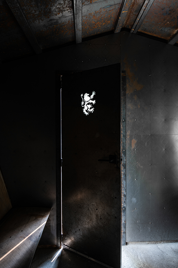 On the door, a fire-lion cutout is illuminated by outdoor light