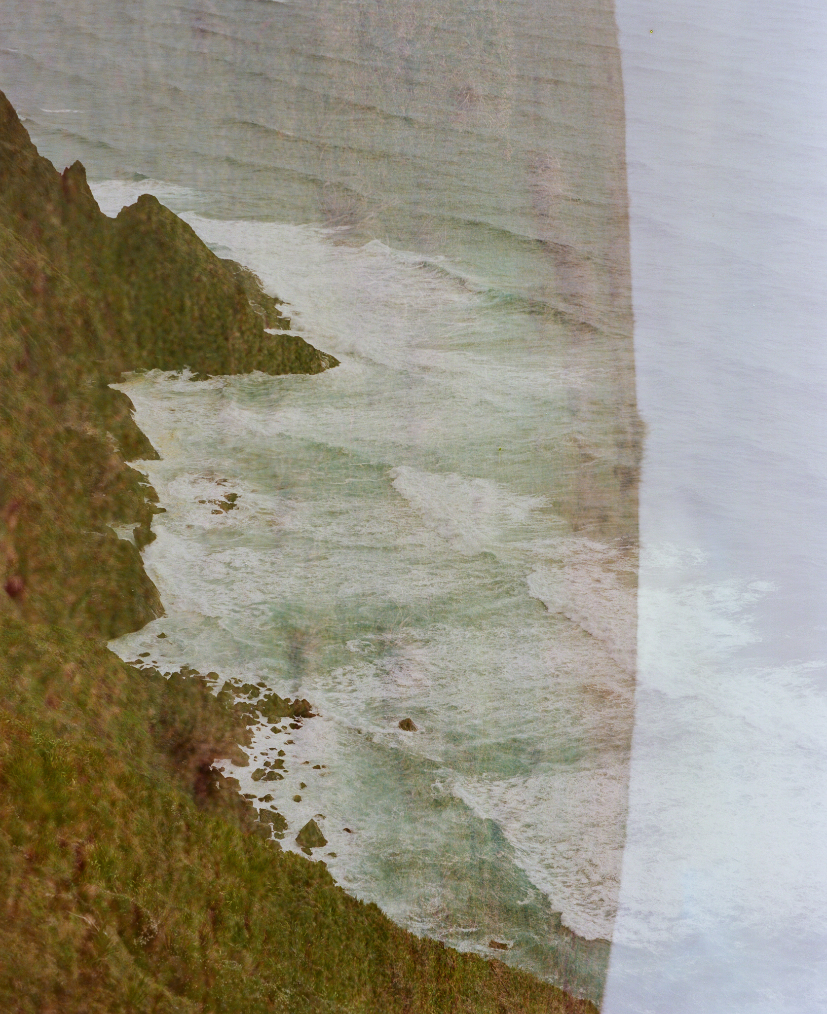 Grassy hillside overlay with cliffs of Te Rerenga Wairua, Cape Reinga.Photograph by H. H.