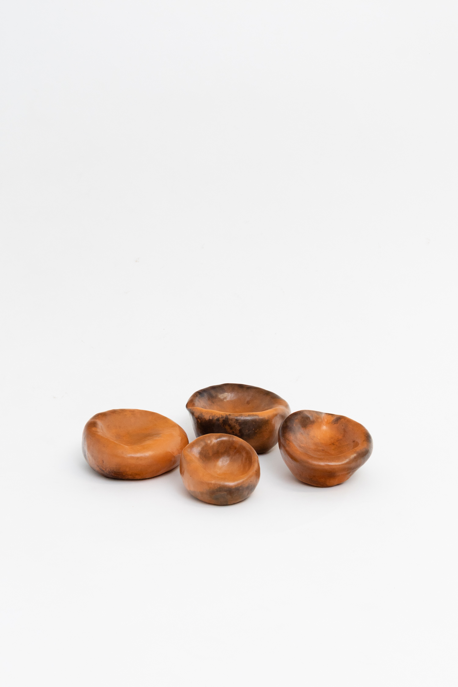 Nicholas Smith, Ashtrays (I - IV), 2025, Pit-fired and burnished terracotta, beeswax, 15 x 15 x 10 cm each