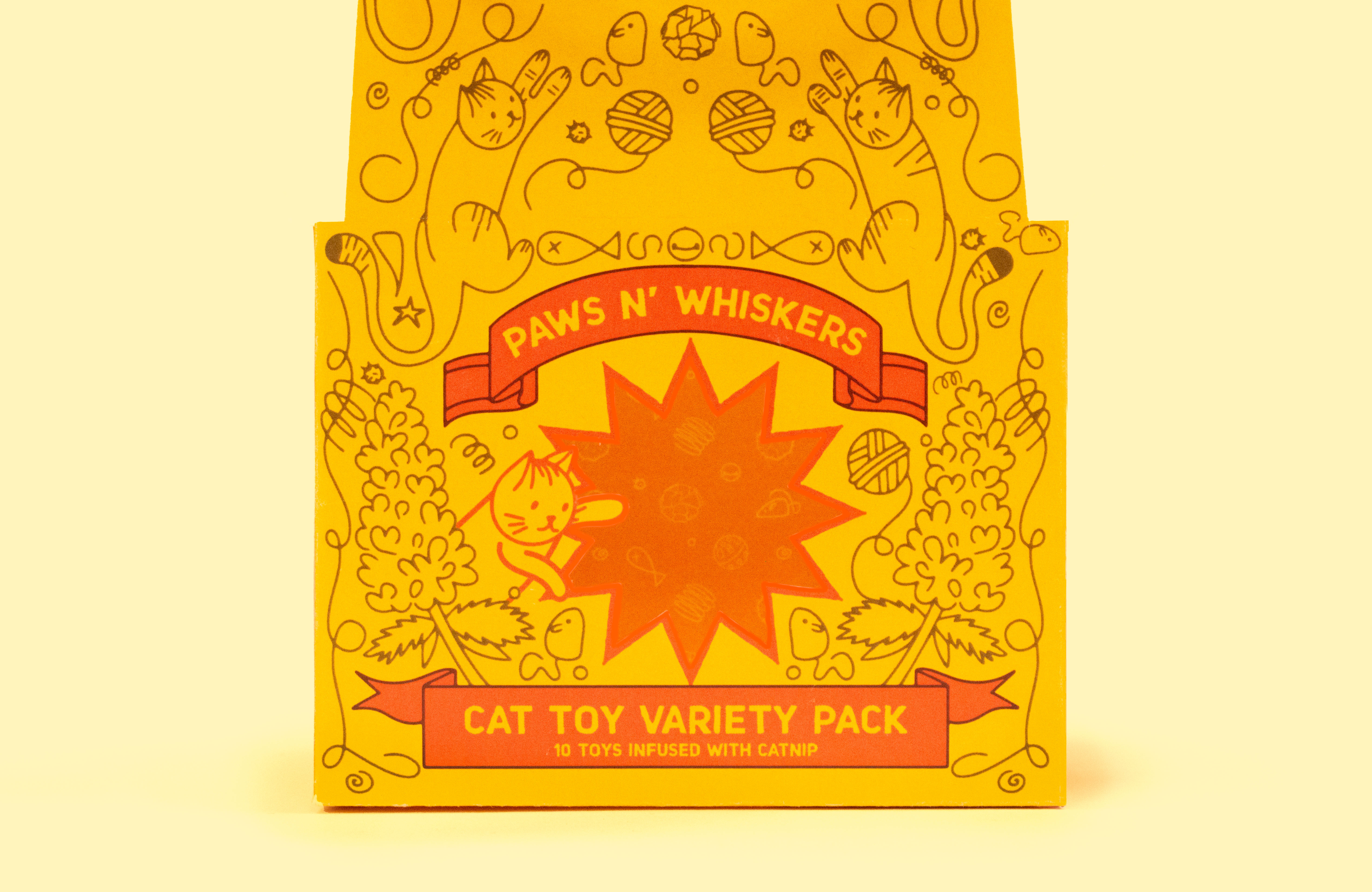 A yellow studio shot featuring a front and center package that shows the detail of hand drawn cat and herb illustrations.