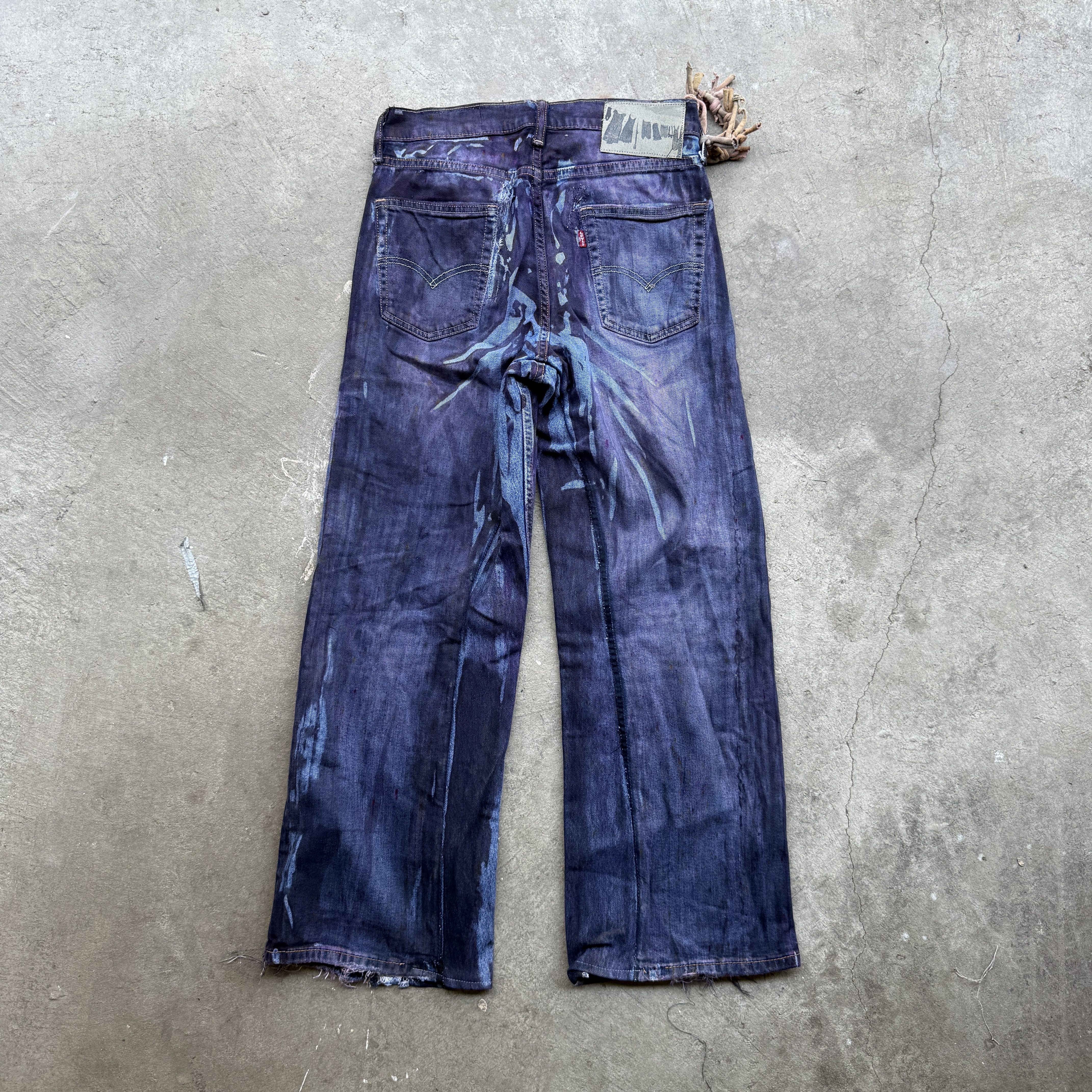 Reclaimed vintage surplus denim allover printed with copper, aluminum, iron & textile dye. Tailored to give a straight/wide fit. Fitted with dyed scrap chain, leather patches, and custom buttons