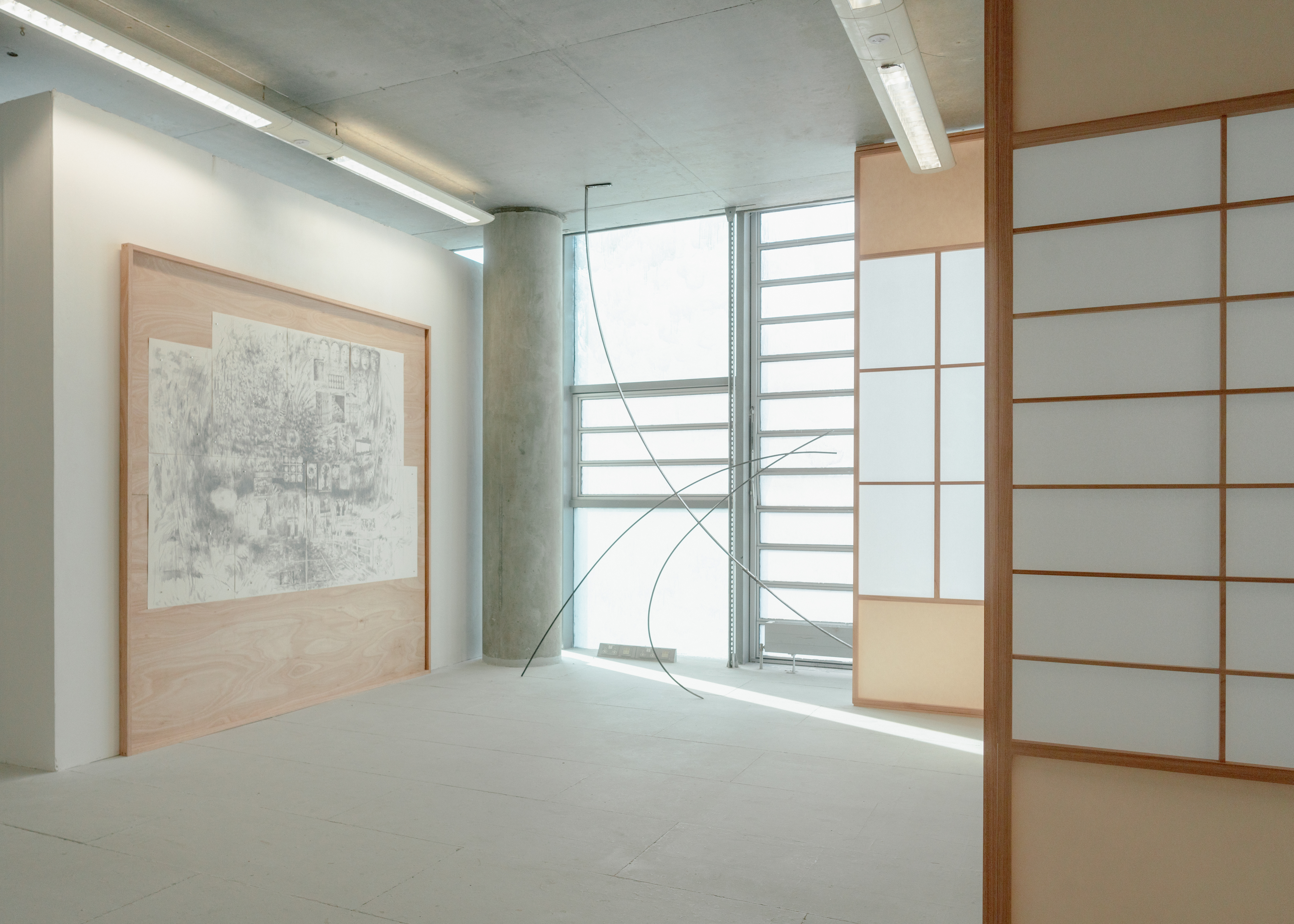Installation featuring The Nightmare (distant deeps or skies), 2025. Graphite on drawing paper with magnets in plywood and red grandis artist’s frame, and Bloom II, 2025. Steel, hardware.