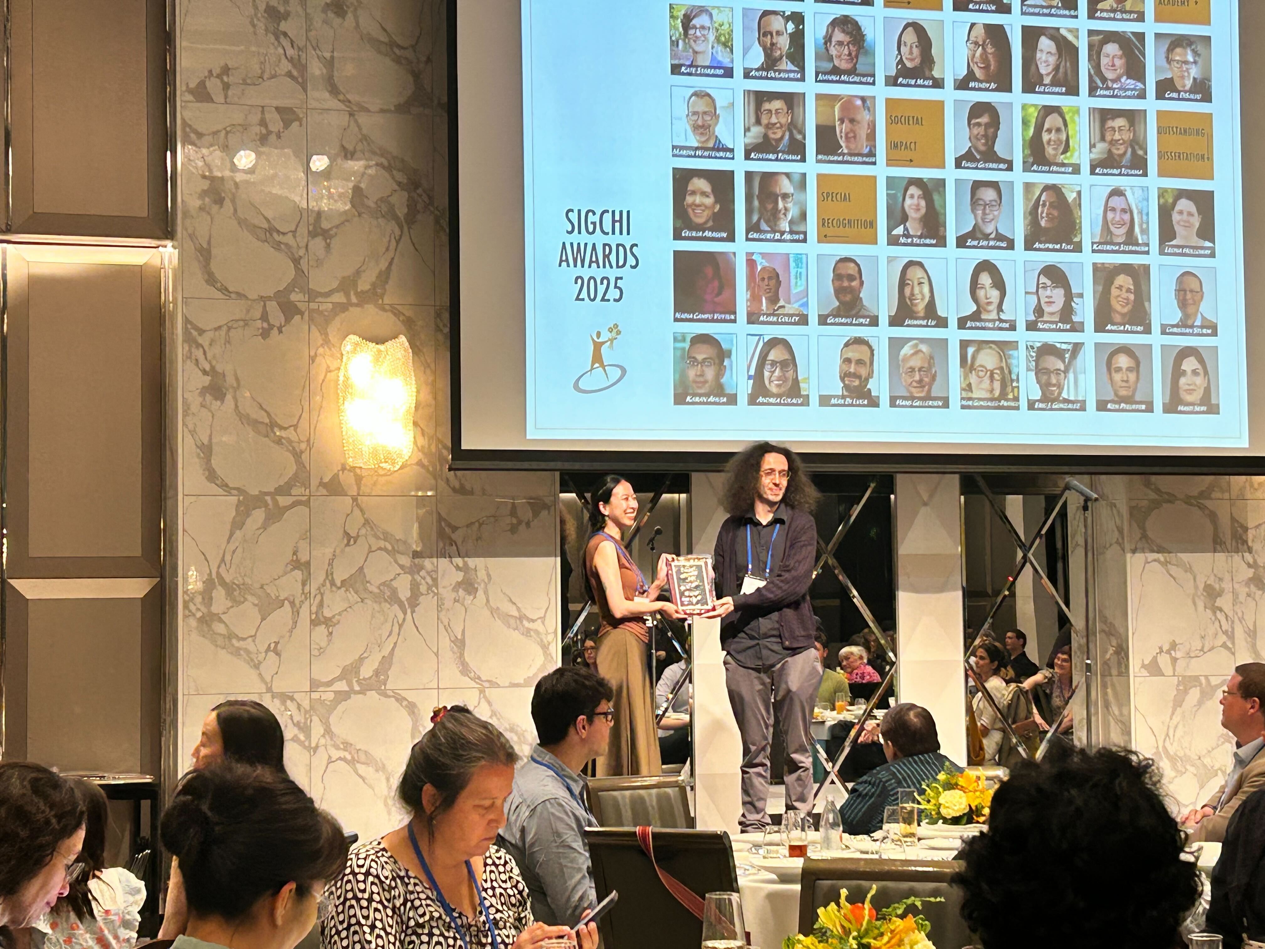 Receiving an ACM SIGCHI Special Recognition at the CHI2025 Award Banquet.