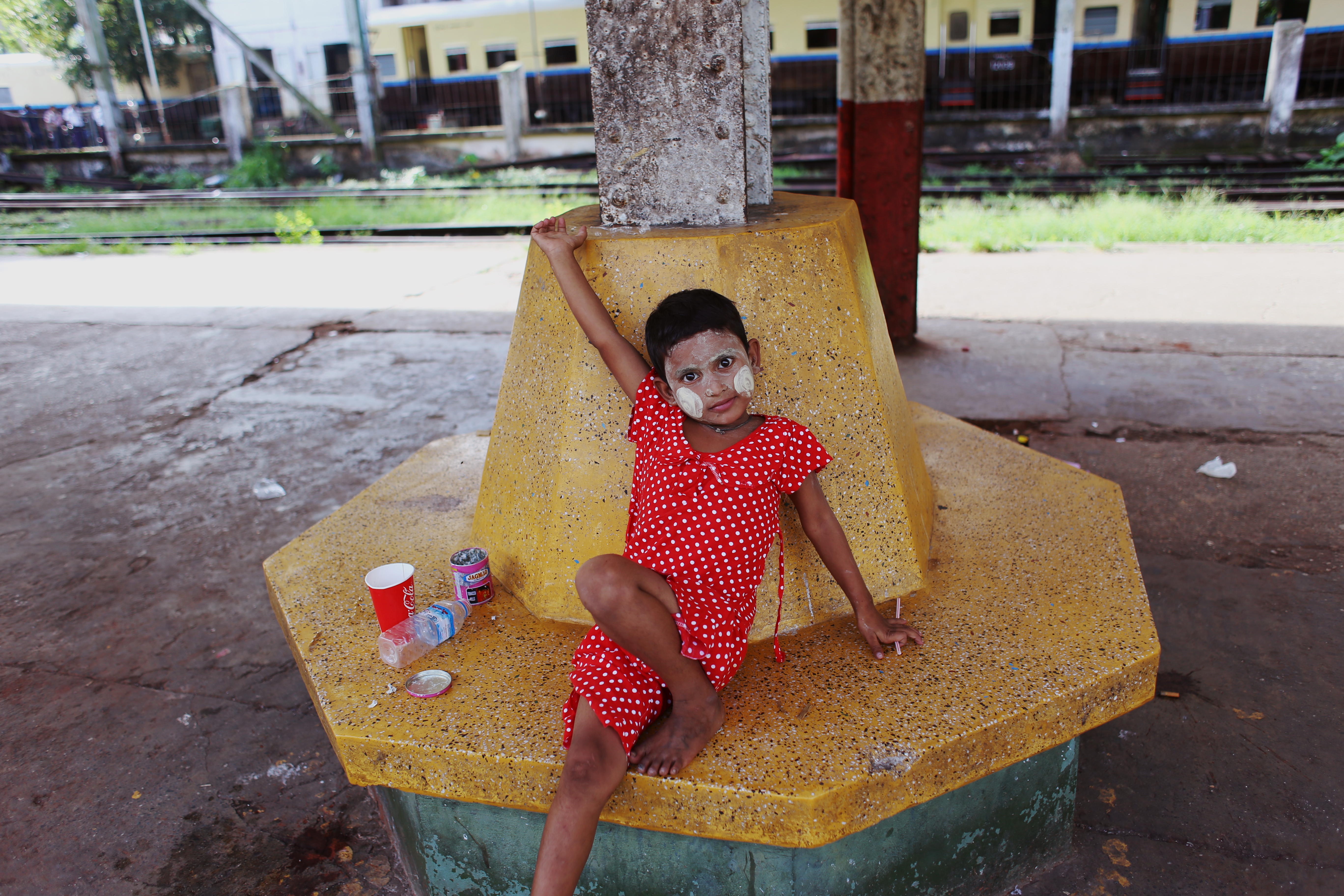Many of the stations we pass are nothing more than wooden sheds, open to the elements. A young girl’s face is decorated with thanaka, a thick chalky cosmetic paste made from ground bark. Thanaka provides both a cooling sensation and protection from the sun, and has been fashionable amongst Burmese women and girls for many hundreds of years. Each woman applies it in a different unique design. It is believed that it helps fight acne and smooth the skin.