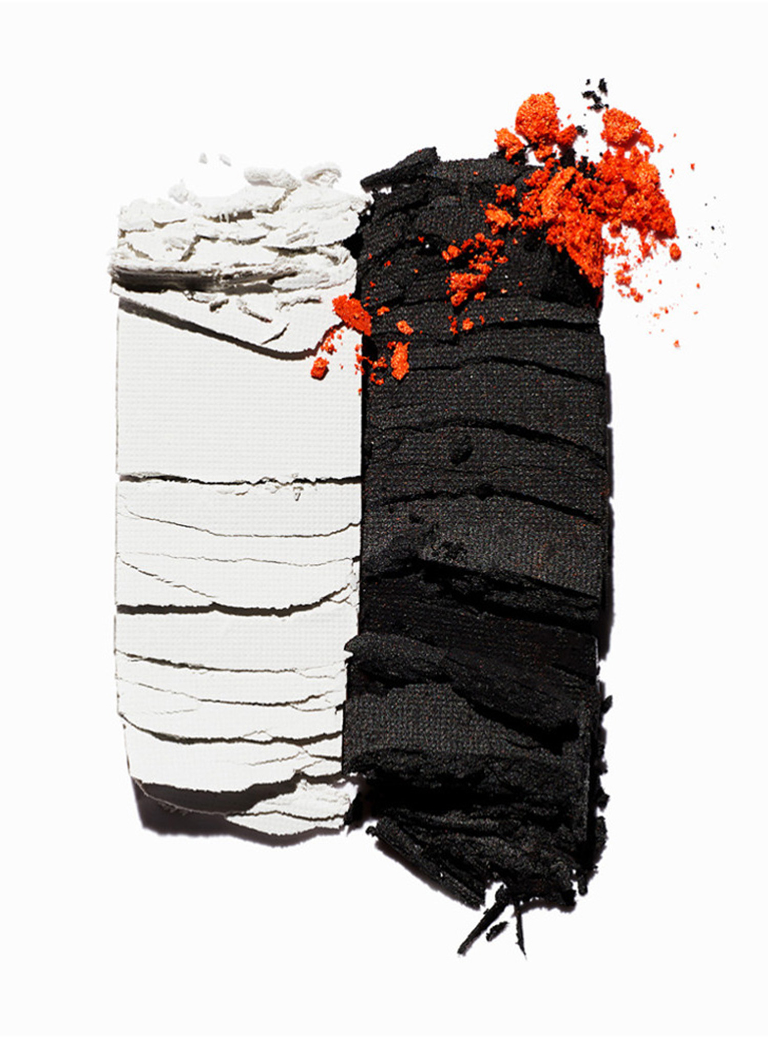 KMA stylist Sara Wacksman designs set for texture photo of soft black white and orange powder scattered on a white background