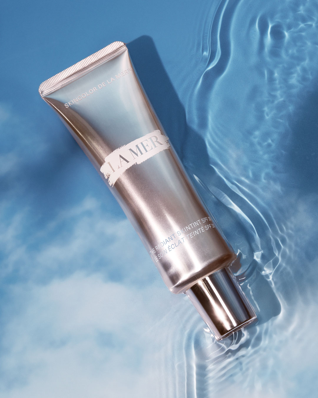KMA stylist Rachel Haas creates a water wonderland using La Mer Skin Tint tube and a sky background with water on top