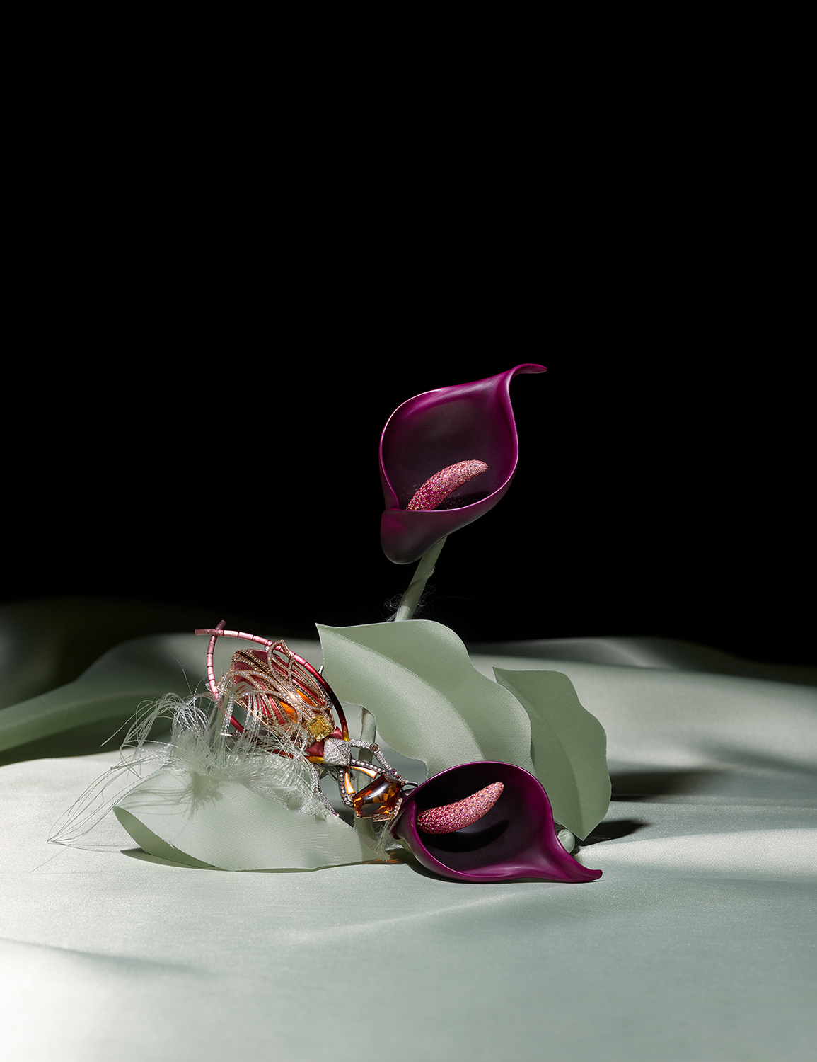 KMA photographer Isabelle Bonjean shoots photograph of gold jewelry for Faux Q with purple flowers and a black background