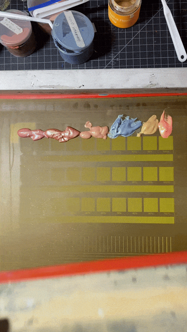a test print of multiple colors. notice how the appearance of a blob of ink changes compared to a thin layer.