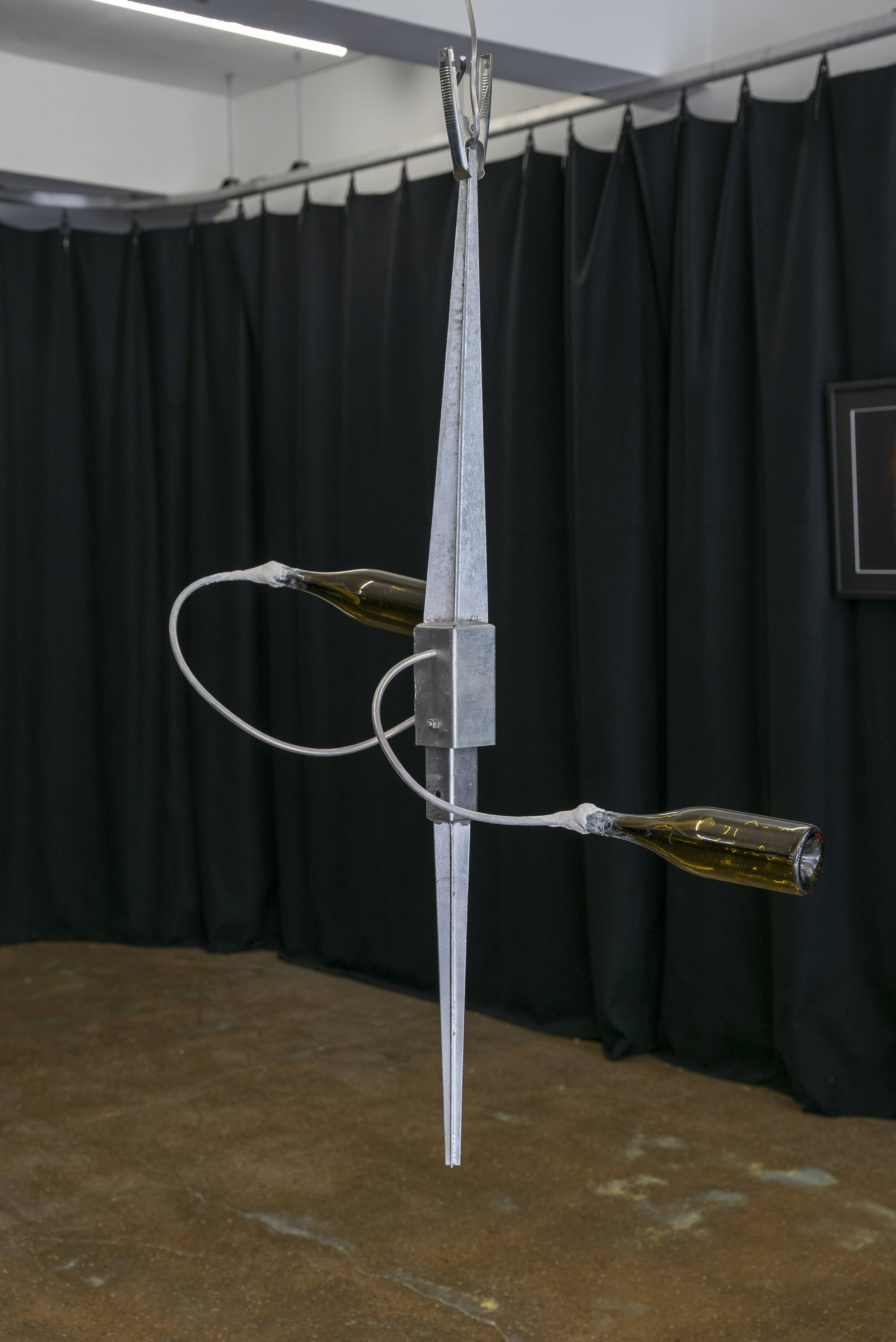 Greater Reward, 2022, Wine Bottles, Fence Post Spikes, Aluminium, Epoxy Putty. Dimensions variable.