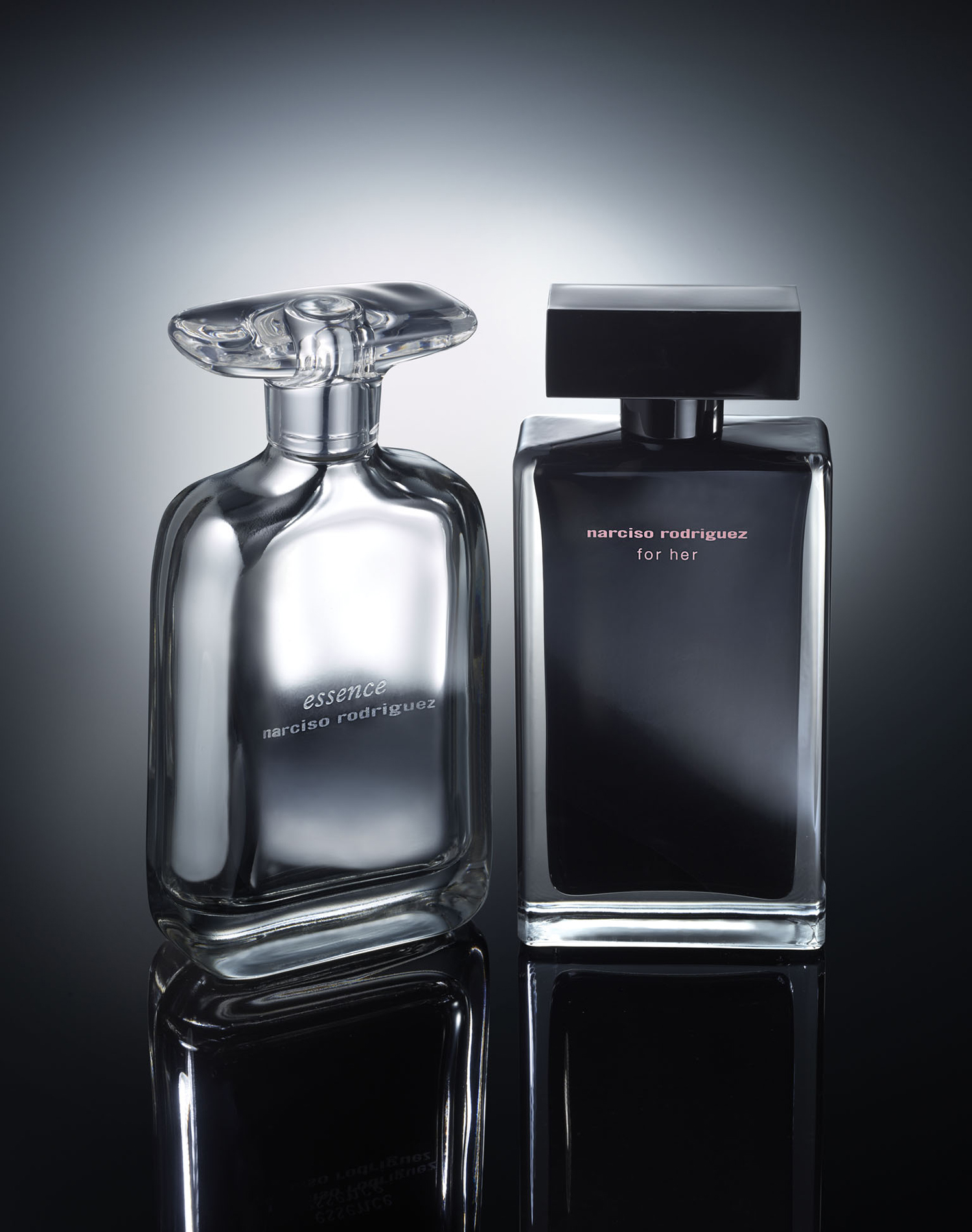 KMA photographer Daniel Schweizer photographs clear and black bottles of perfume with a white and black background 