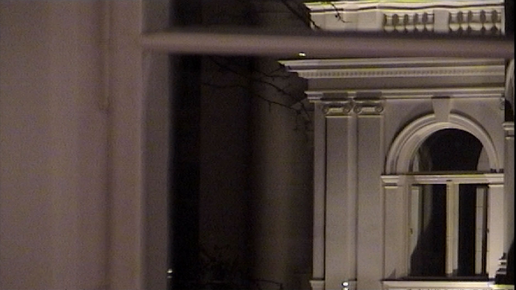 1/1 — DARKNESS SPOKEN.While in residency at the Museum Quarter in Vienna, Austria, in the spring of 2021, Darkness Spoken began as a research project focused on female Austrian fiction writers and poets such as Ingeborg Bachmann, Elfriede Jelinek, and Friederike Mayröcker. Reading, writing, and drawing in the studio and taking walks each day while much of the city was still closed encouraged, if not necessitated, isolation and reflection on the banality of everyday activities and routine.Taking its name from an Ingeborg Bachmann poem (and collection of poetry of the same name), this exploration considers autobiography and performance, drawing upon trauma, memory, and repetition, as well as the landscape of Vienna. Quinn shot the video footage on a Hi8 camcorder in her studio living space and across the city, selecting the media as one that connects to ideas of accessibility and personal memory. Here, there is a tension between her desire to dematerialize the art object and its opposition—which instead attempts to memorialize fleeting gestures toward some type of permanence.Video still; shot on Hi8 and digitized, 2021-2022.